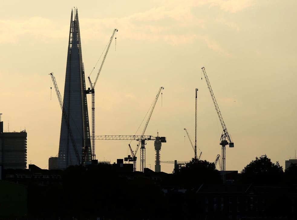 Construction cranes in front of The Shard in London