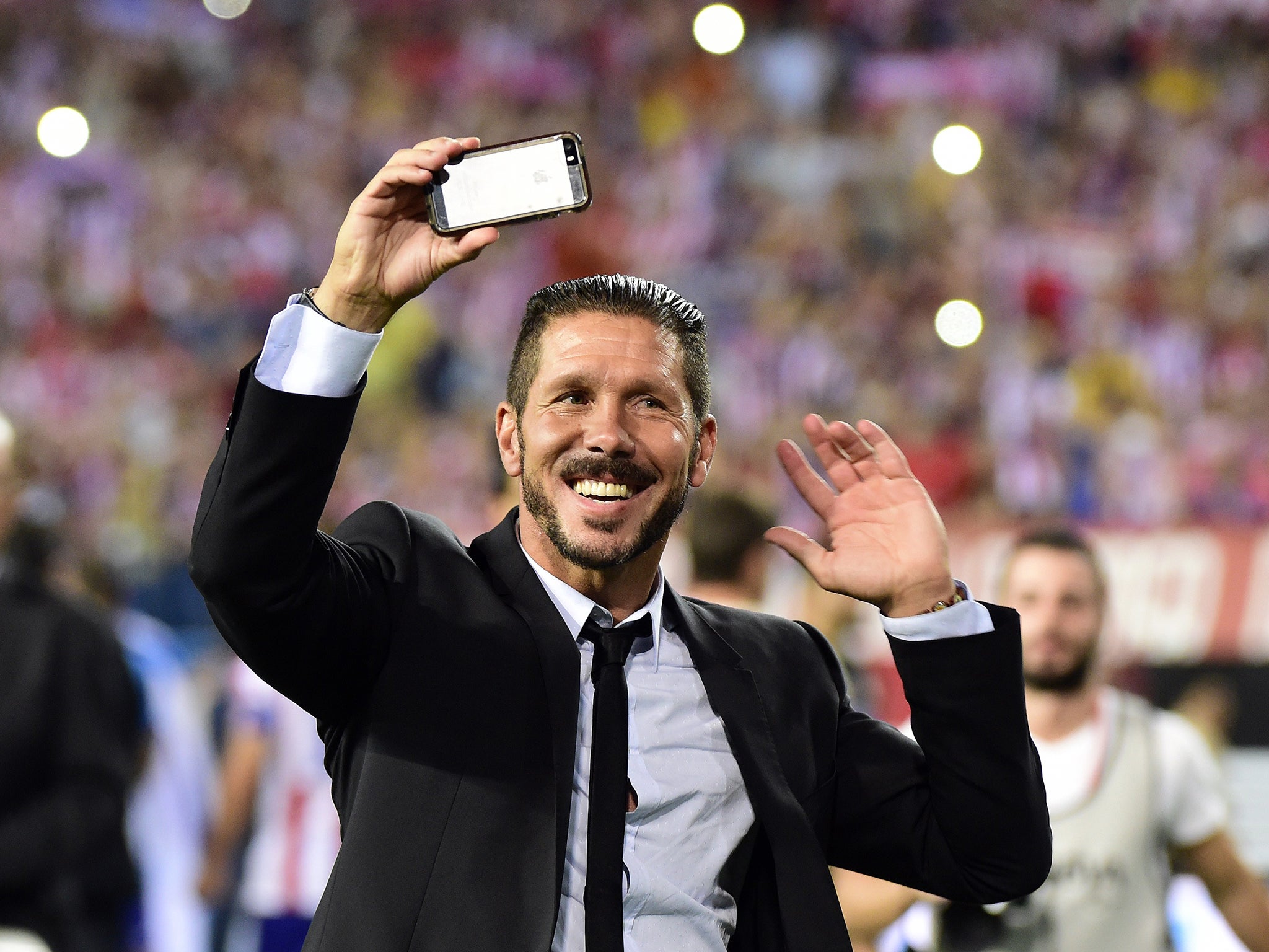 Diego Simeone celebrates Atletico's victory in the Spanish Super Cup