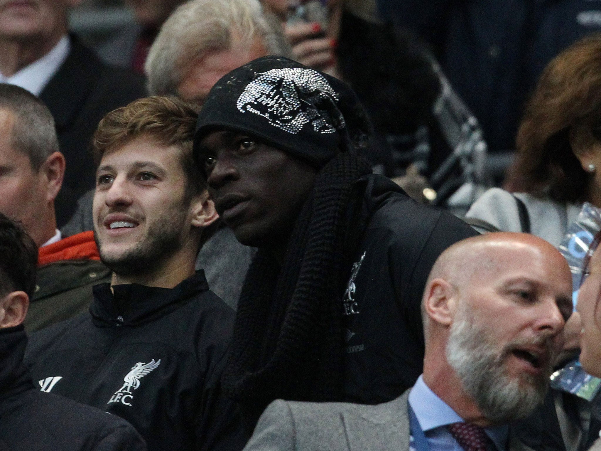 New Liverpool signing Mario Balotelli sits with Adam Lallana during the 3-1 defeat at Manchester CIty