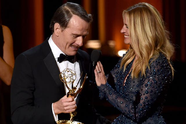 Actor Bryan Cranston (L) accepts Outstanding Lead Actor in a Drama Series for 'Breaking Bad' from actress Julia Roberts onstage at the 66th Annual Primetime Emmy Awards on August 25, 2014.
