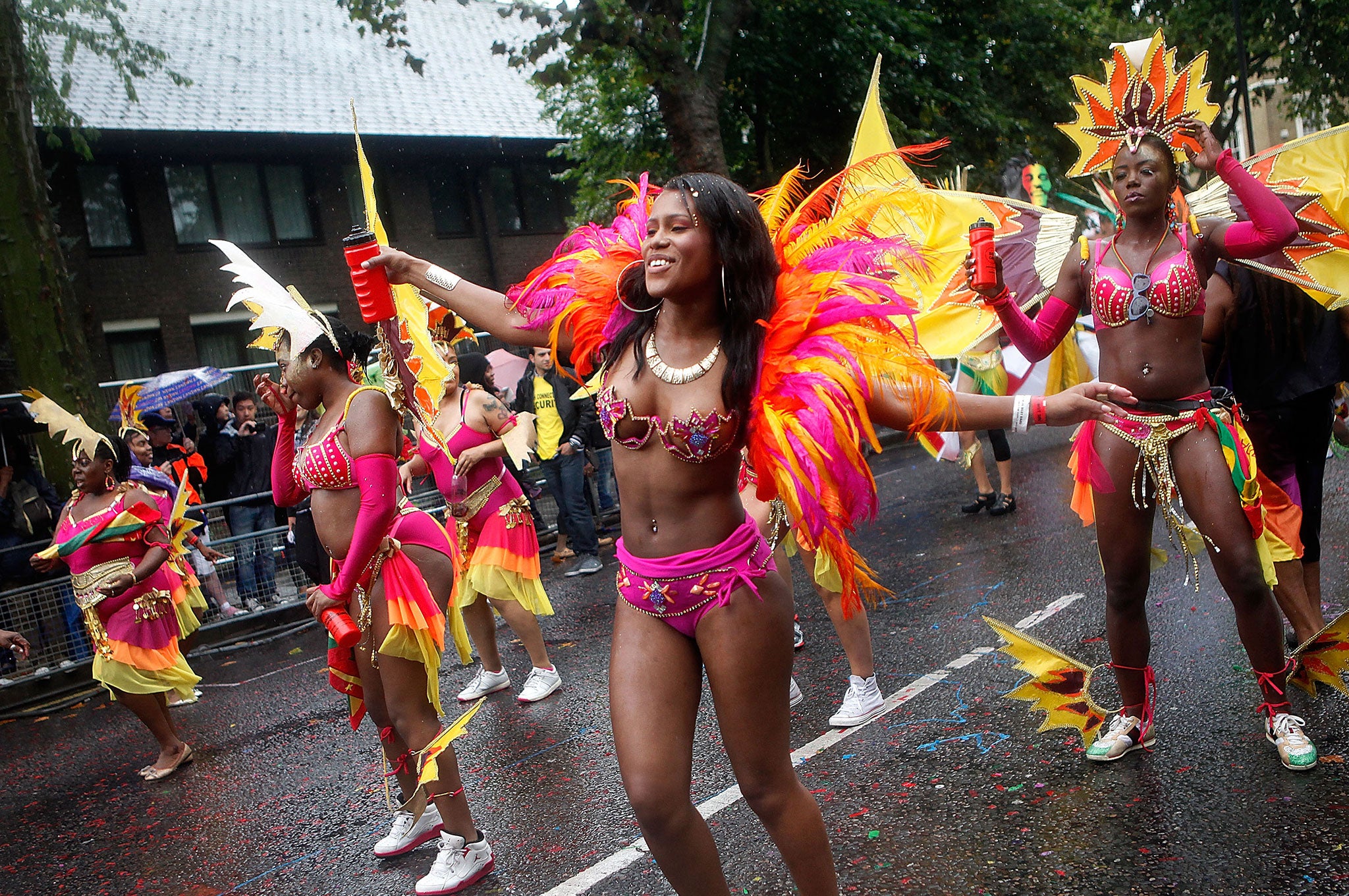 Performers dance through heavy rain during the Notting Hill Carnival in London. Despite the bad weather over 1 million visitors are expected to attend the two-day event which is the largest of its kind in Europe