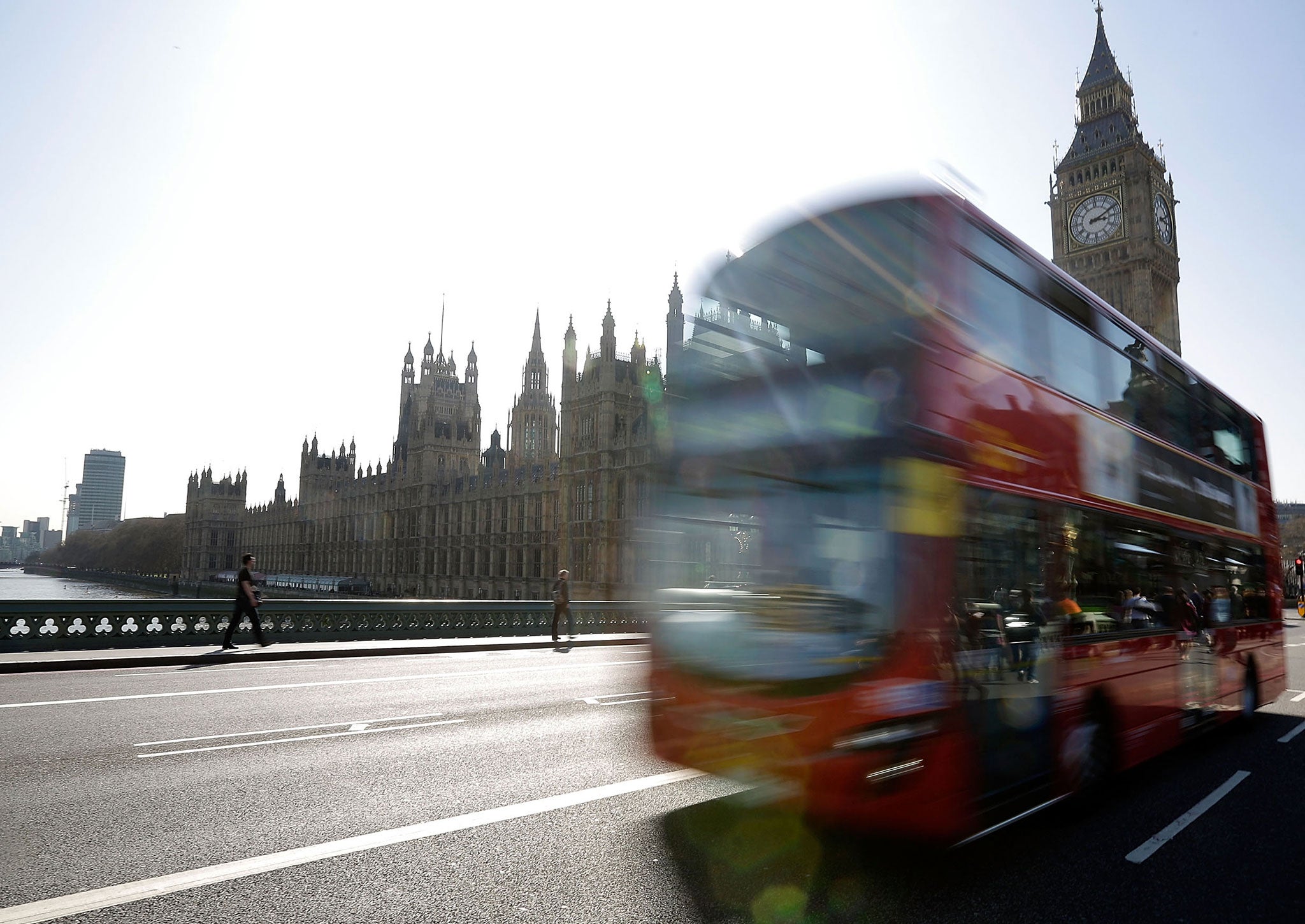 A London bus travels over Westminster Bridge in front of the Houses of Parliament on March 28, 2012 in London, England.