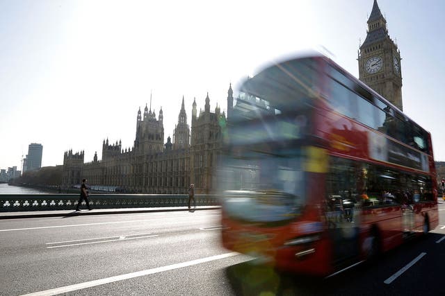 A London bus travels over Westminster Bridge in front of the Houses of Parliament on March 28, 2012 in London, England.