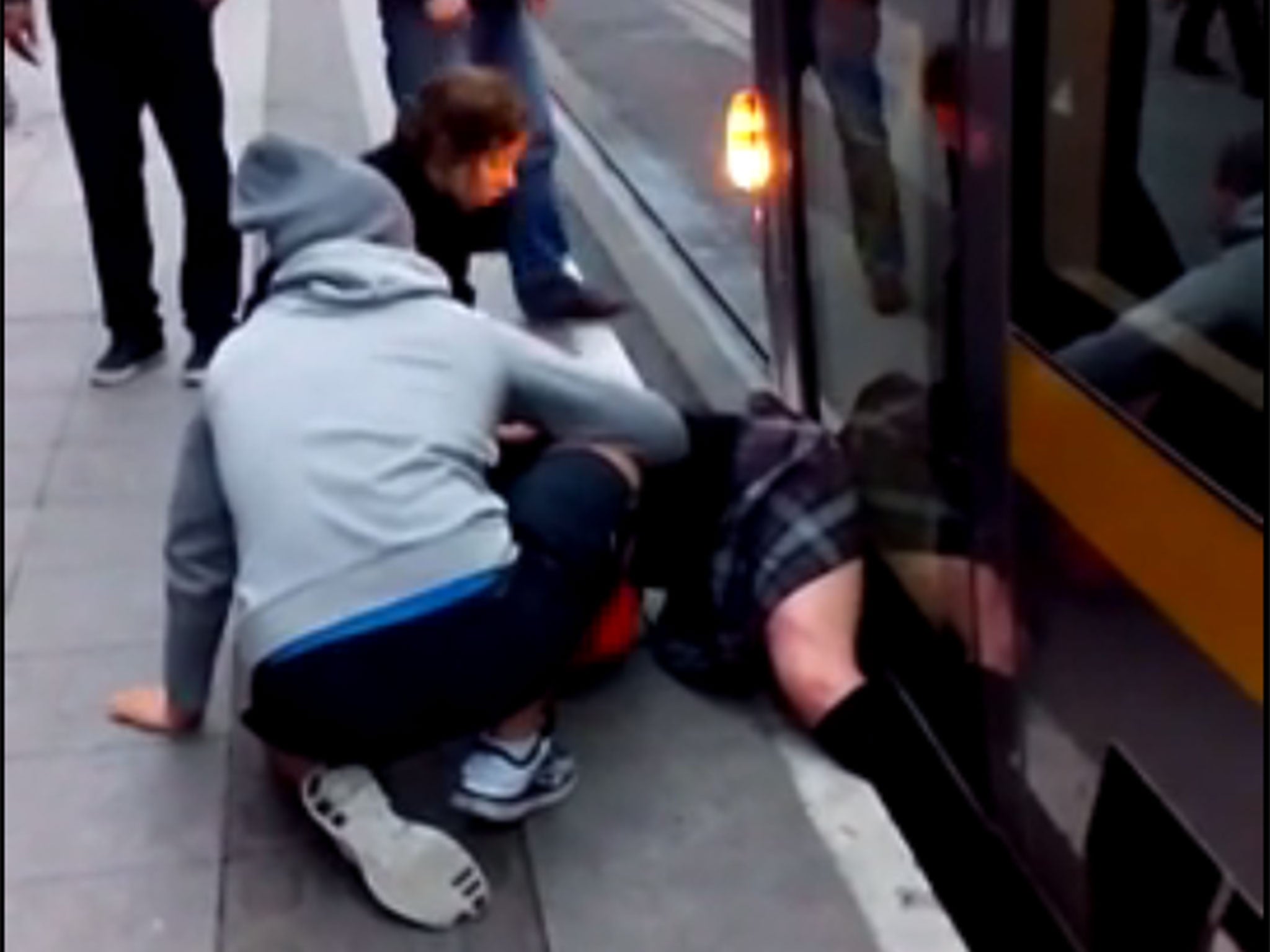 A still from footage showing a schoolgirl trapped under a tram in Dublin
