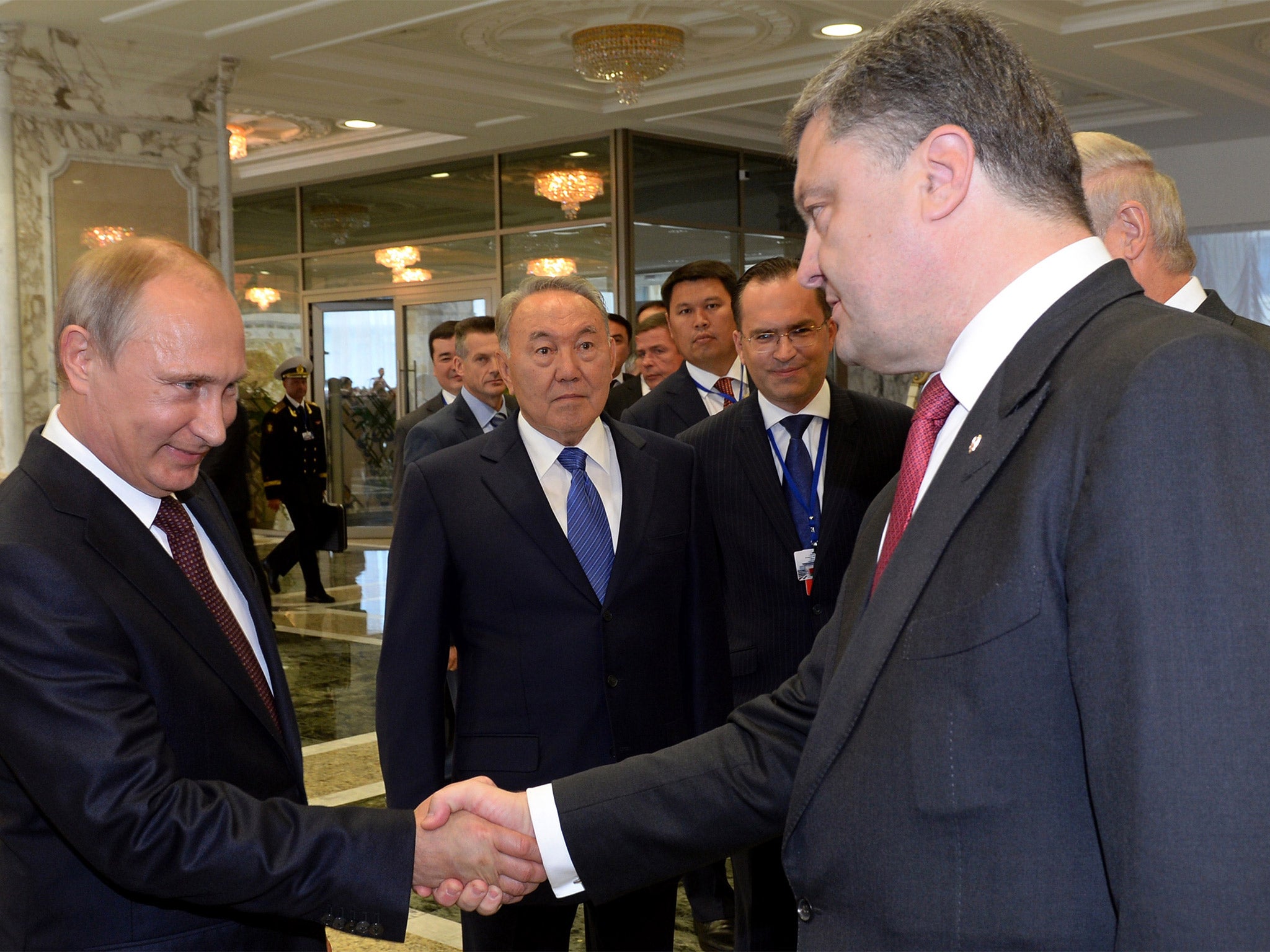 Vladimir Putin and Petro Poroshenko shake hands in Minsk