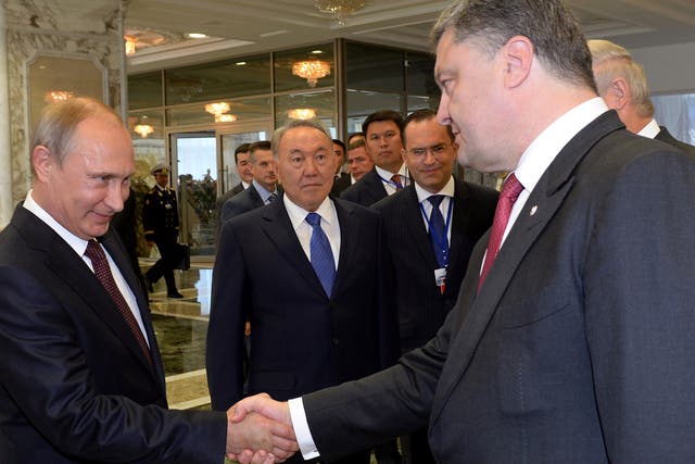 Vladimir Putin and Petro Poroshenko shake hands in Minsk