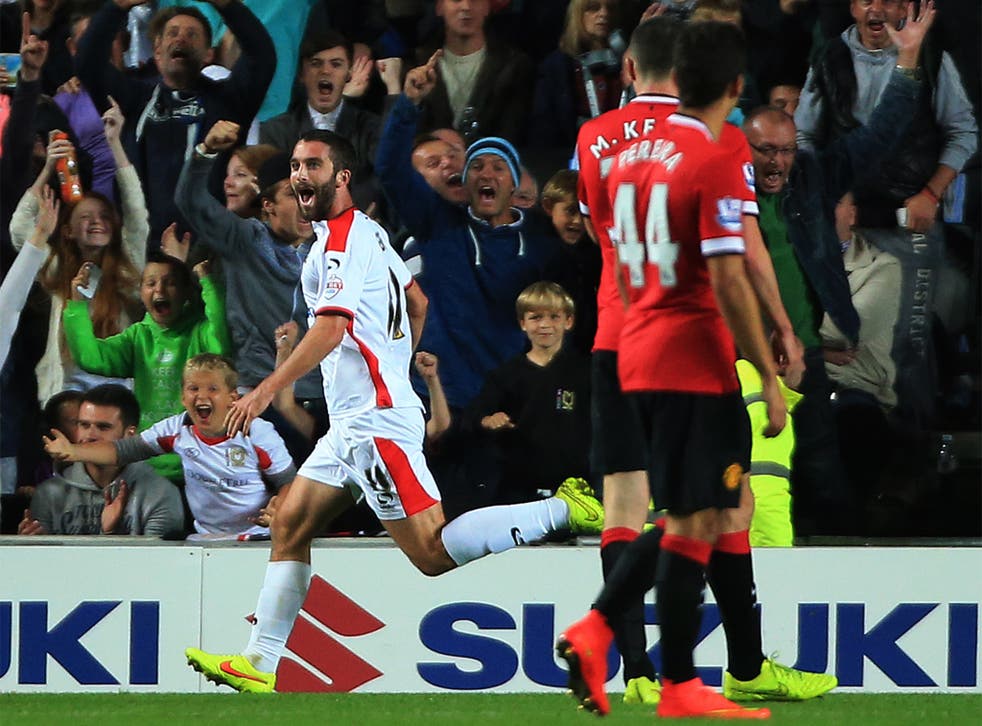 MK Dons' Will Grigg celebrates after scoring the second