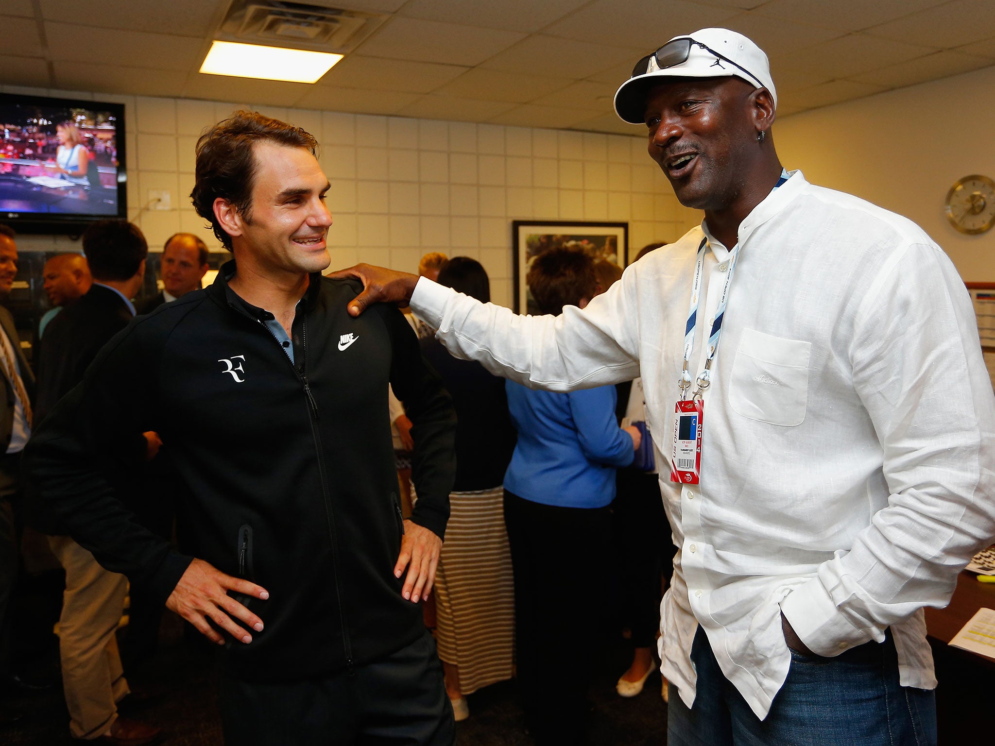 Roger Federer is greeted by Michael Jordan following his victory over Marinko Matosevic