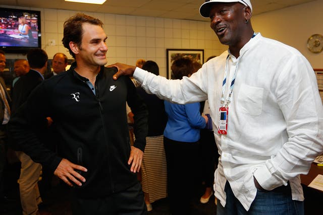 Roger Federer is greeted by Michael Jordan following his victory over Marinko Matosevic 
