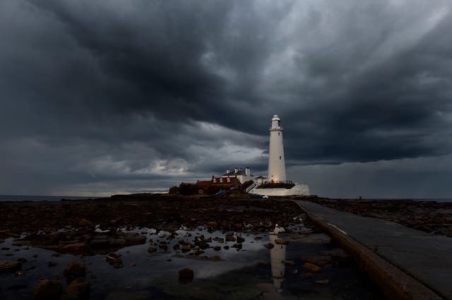 Storm clouds gather over St. Mary's lighthouse in Whitley Bay, North Tyneside