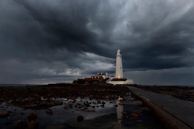 Storm clouds gather over St. Mary's lighthouse in Whitley Bay, North Tyneside
