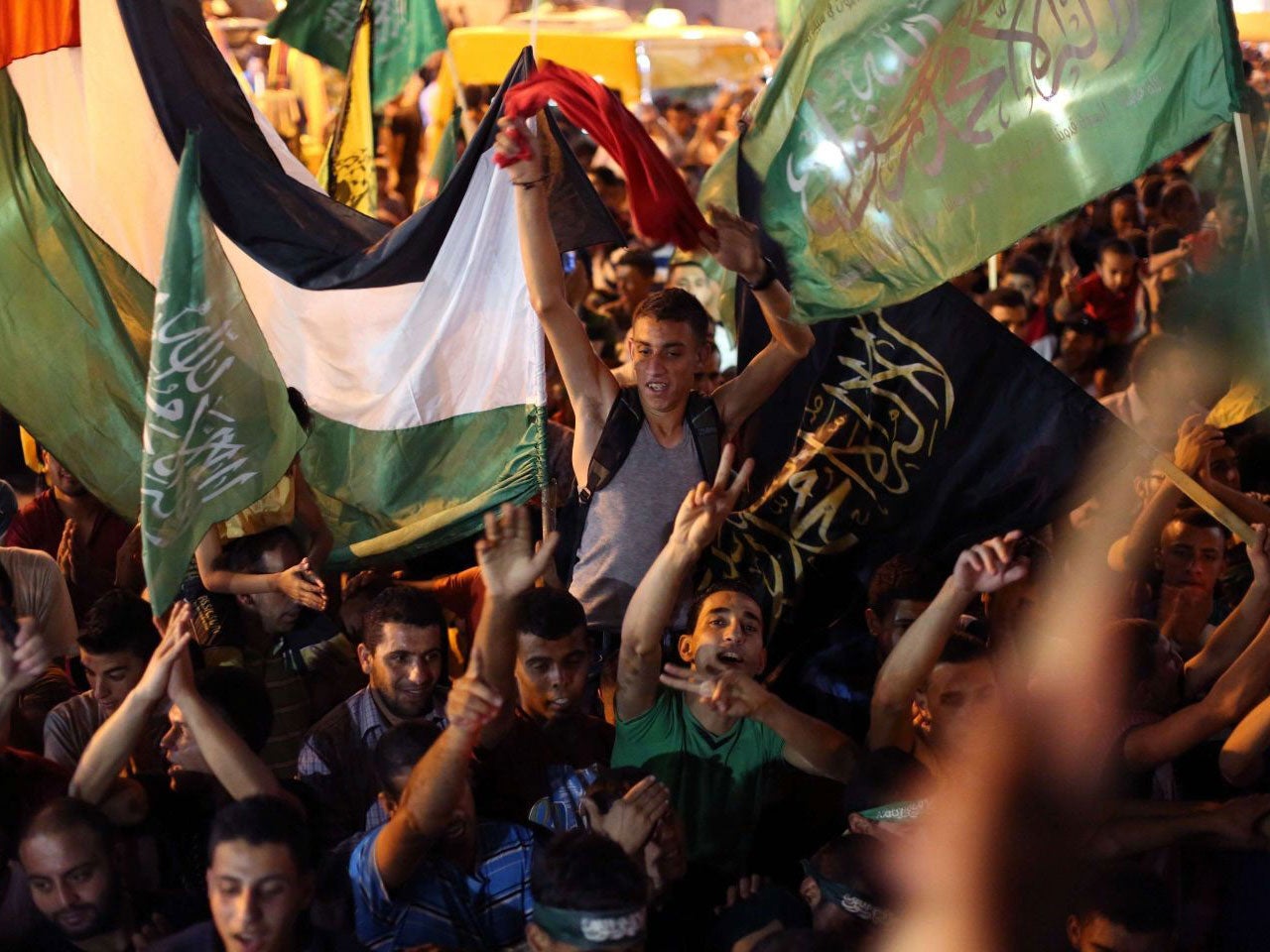 Palestinians celebrate what they said was a victory by Palestinians in Gaza over Israel following a ceasefire, in the West Bank city of Ramallah on August 26