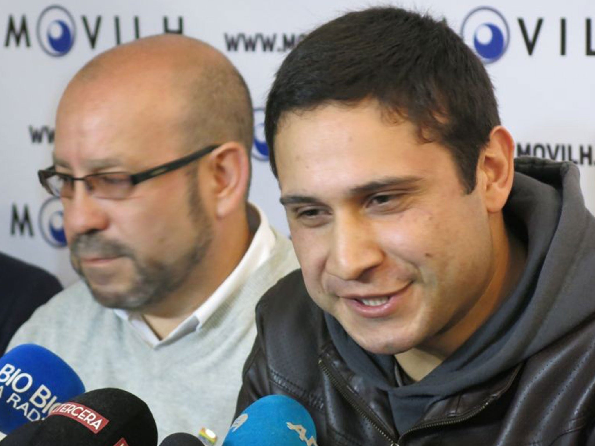 Chilean sailor Mauricio Ruiz, right, reveals he is gay during a press conference in Santiago