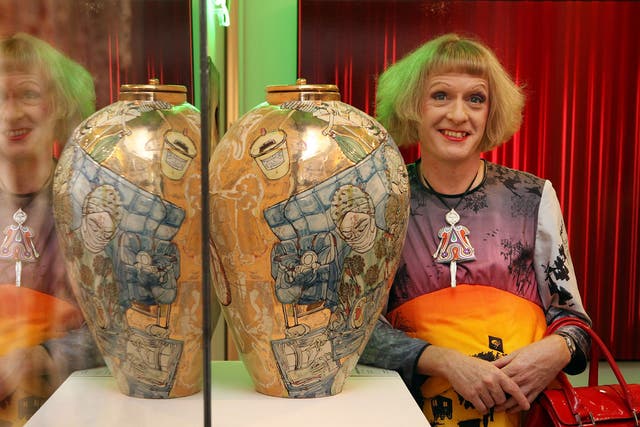 Cheeky chappie approach: Grayson Perry poses with his artwork in 2009