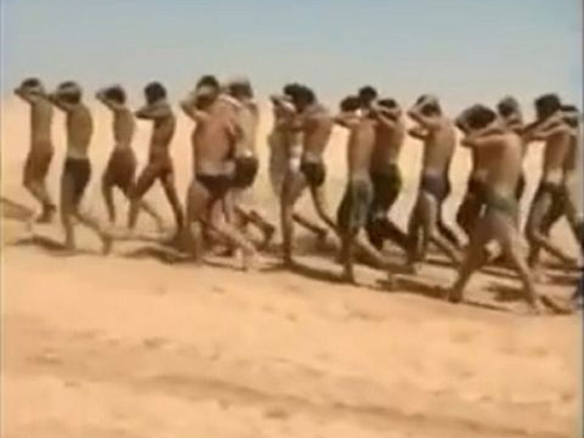 Young men in underwear being marched barefoot along a desert road before being allegedly executed by Isis