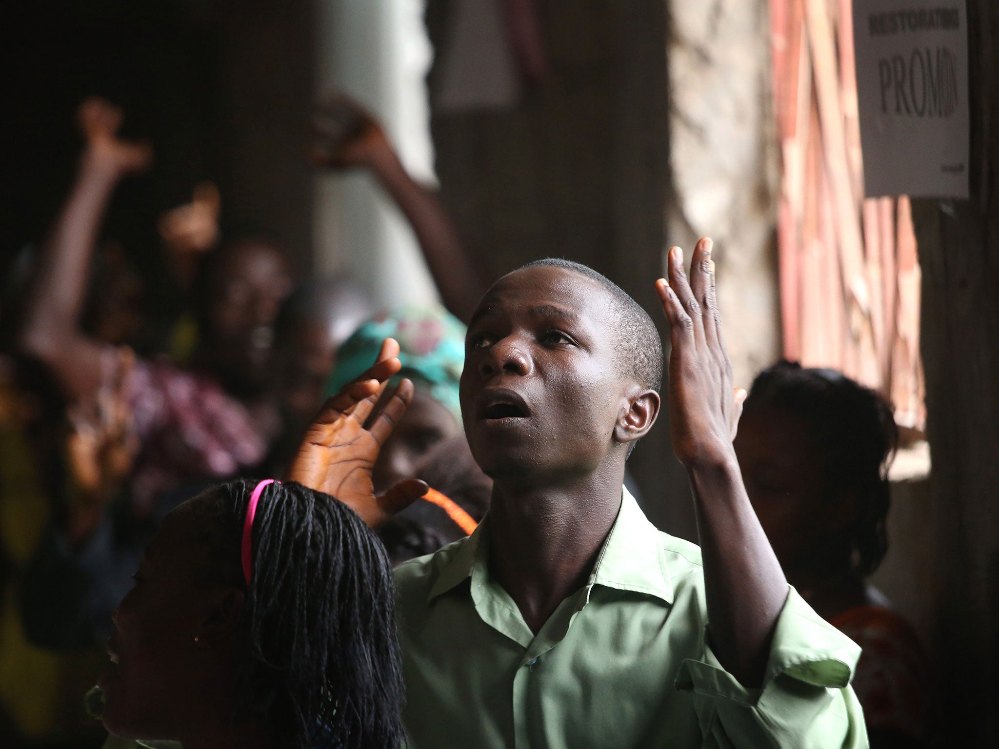 Parishioners pray for deliverance from Ebola at a church service in Dolo Town,
Liberia