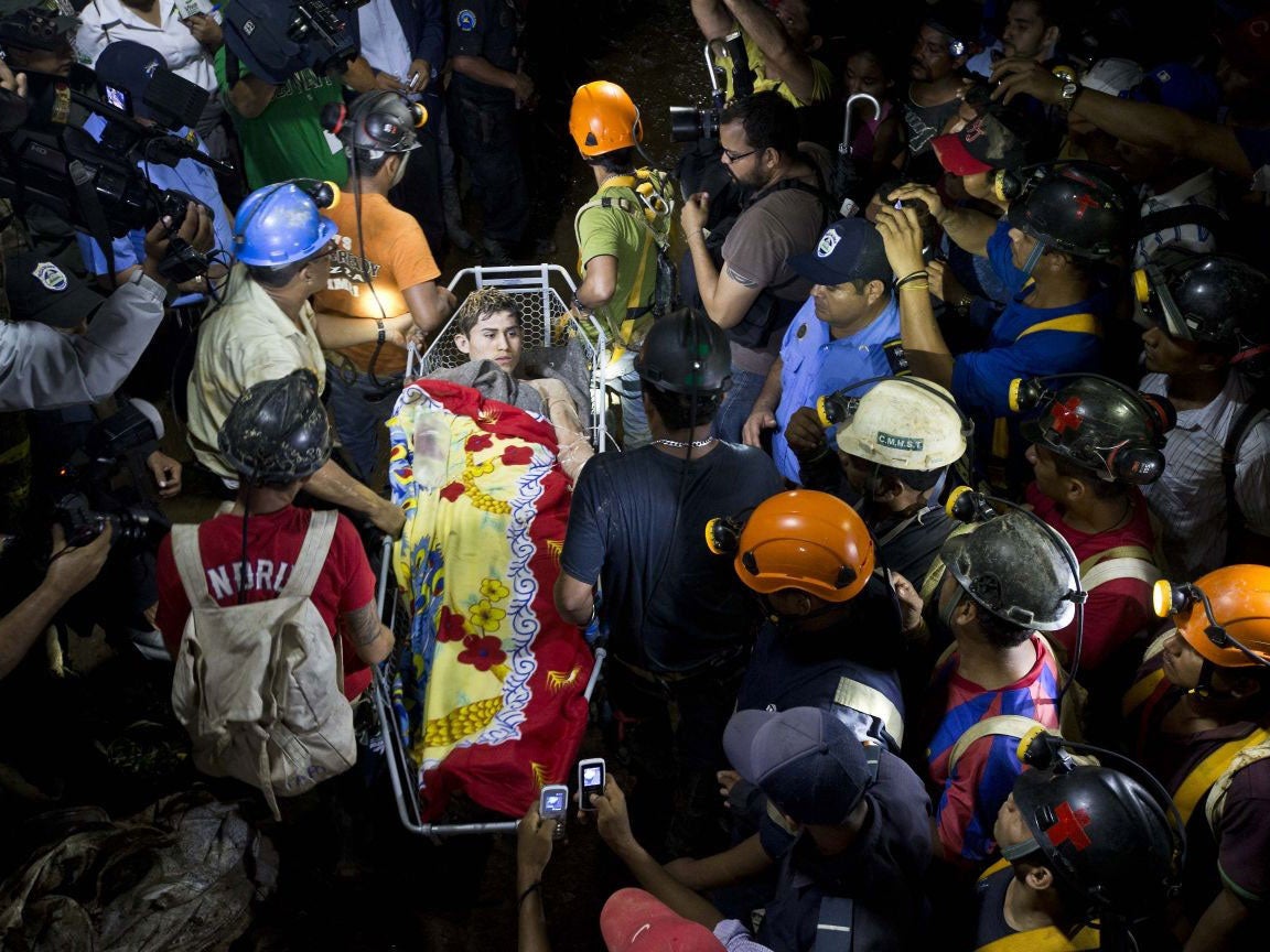 A rescued miner is carried away on a stretcher as he is evacuated from the El Comal gold and silver mine