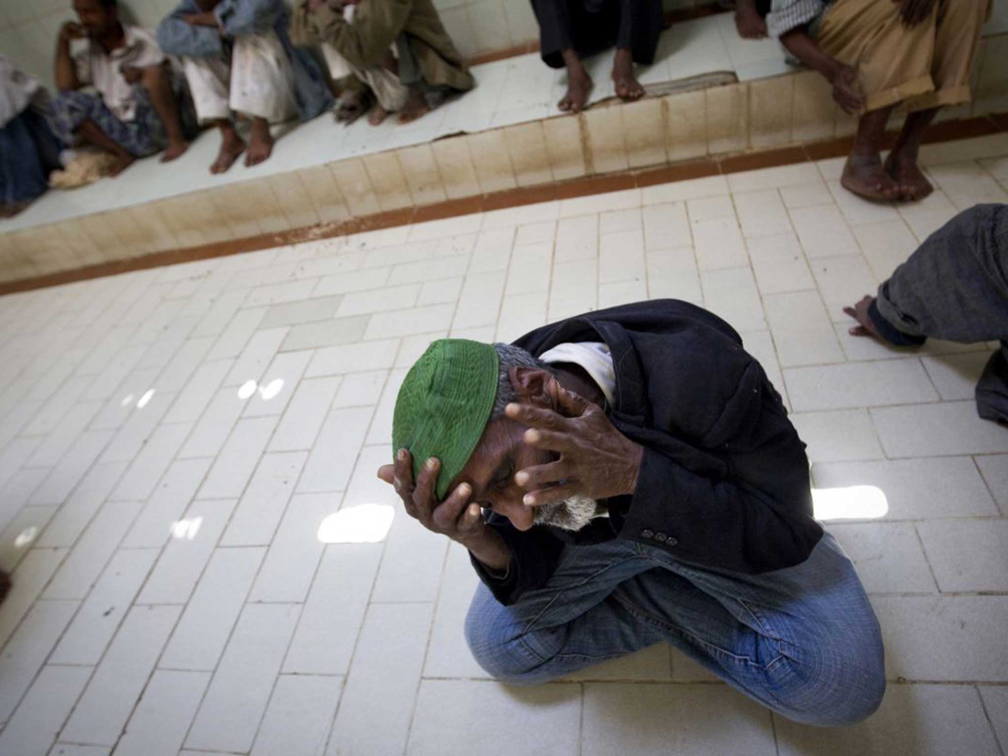 Mentally disabled Pakistani patients sit in an adult patients' ward at Edhi village on the outskirts of Karachi