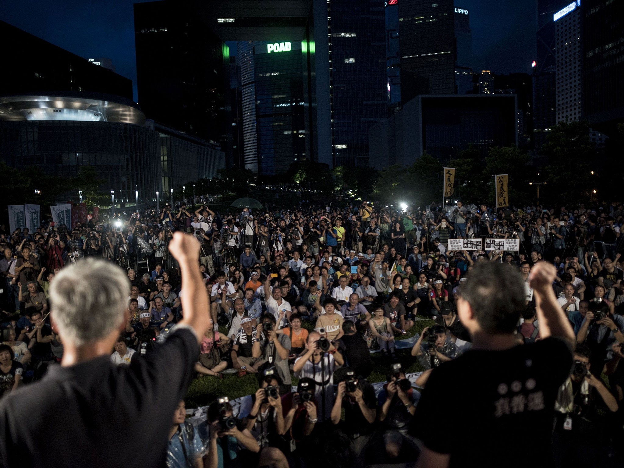 Benny Tai (R), co-founder of the Occupy Central movement, rallies with democracy activists next to the Hong Kong government complex on August 31