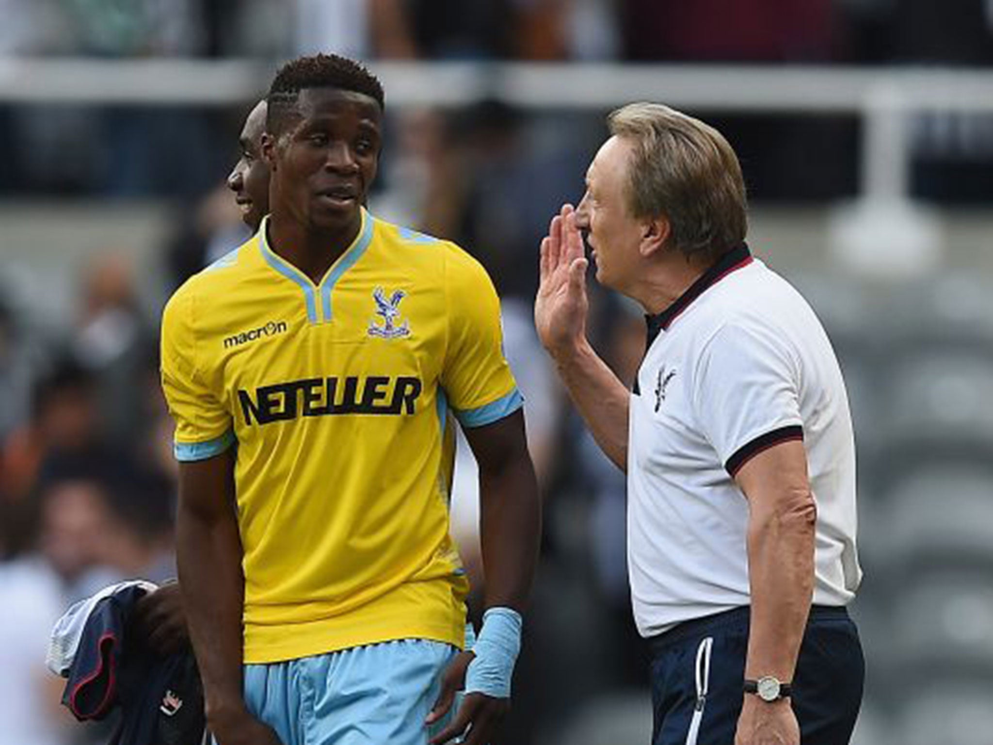 Palace’s new manager, Neil Warnock, high-fives with Wilfried Zaha after the final whistle