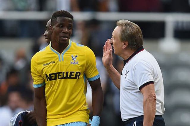Palace’s new manager, Neil Warnock, high-fives with Wilfried Zaha after the final whistle