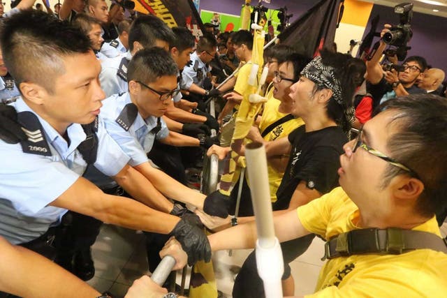 Pro-democracy protesters clashing with police officers outside the Hong Kong government complex 