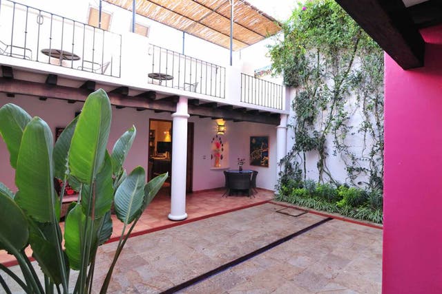 Tropical tastes: Bright colours and cool corners define the casa's central courtyard and kitchen