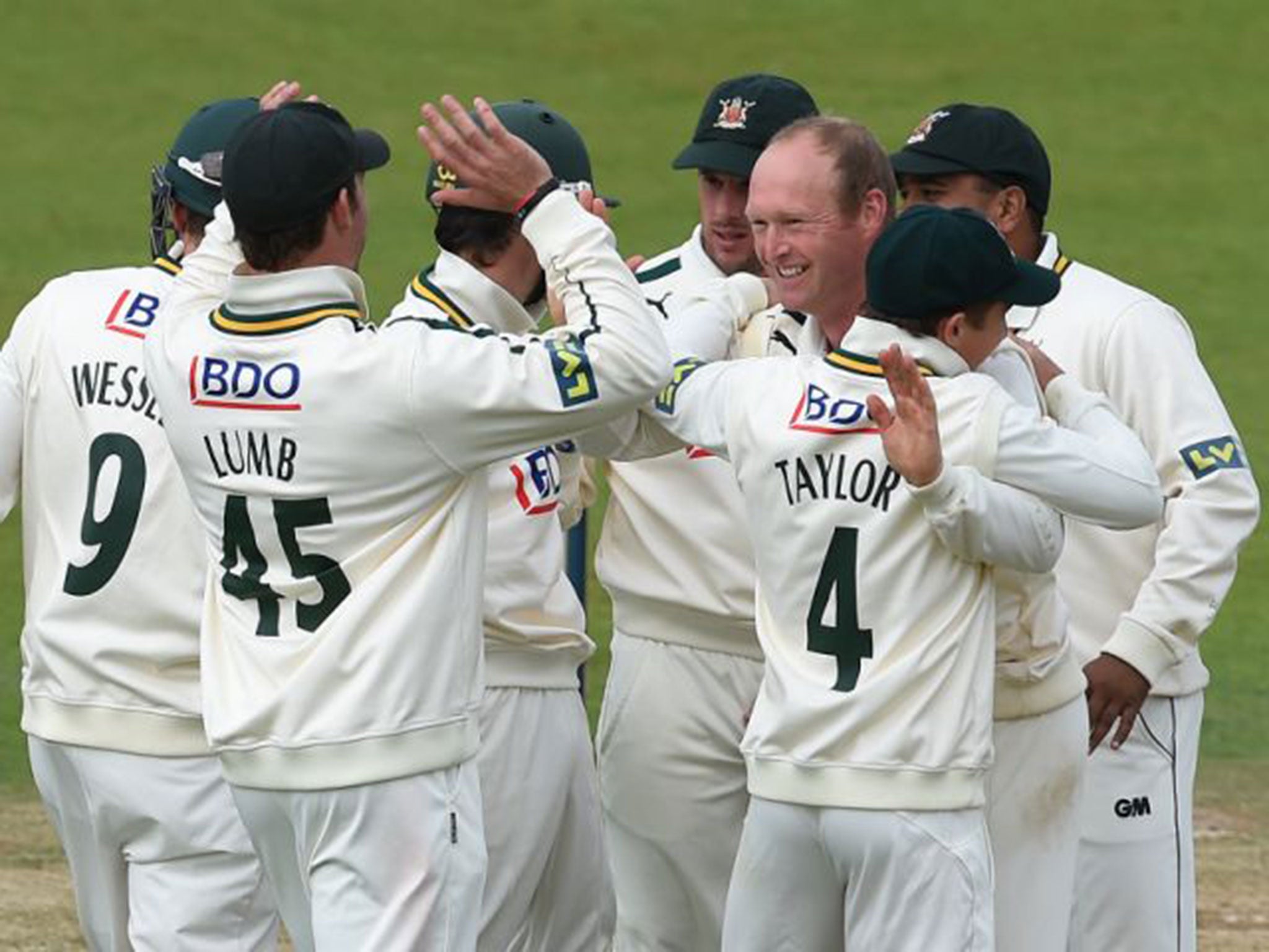 Gary Keedy (third right) celebrates having Mark Stoneman caught behind for his first wicket