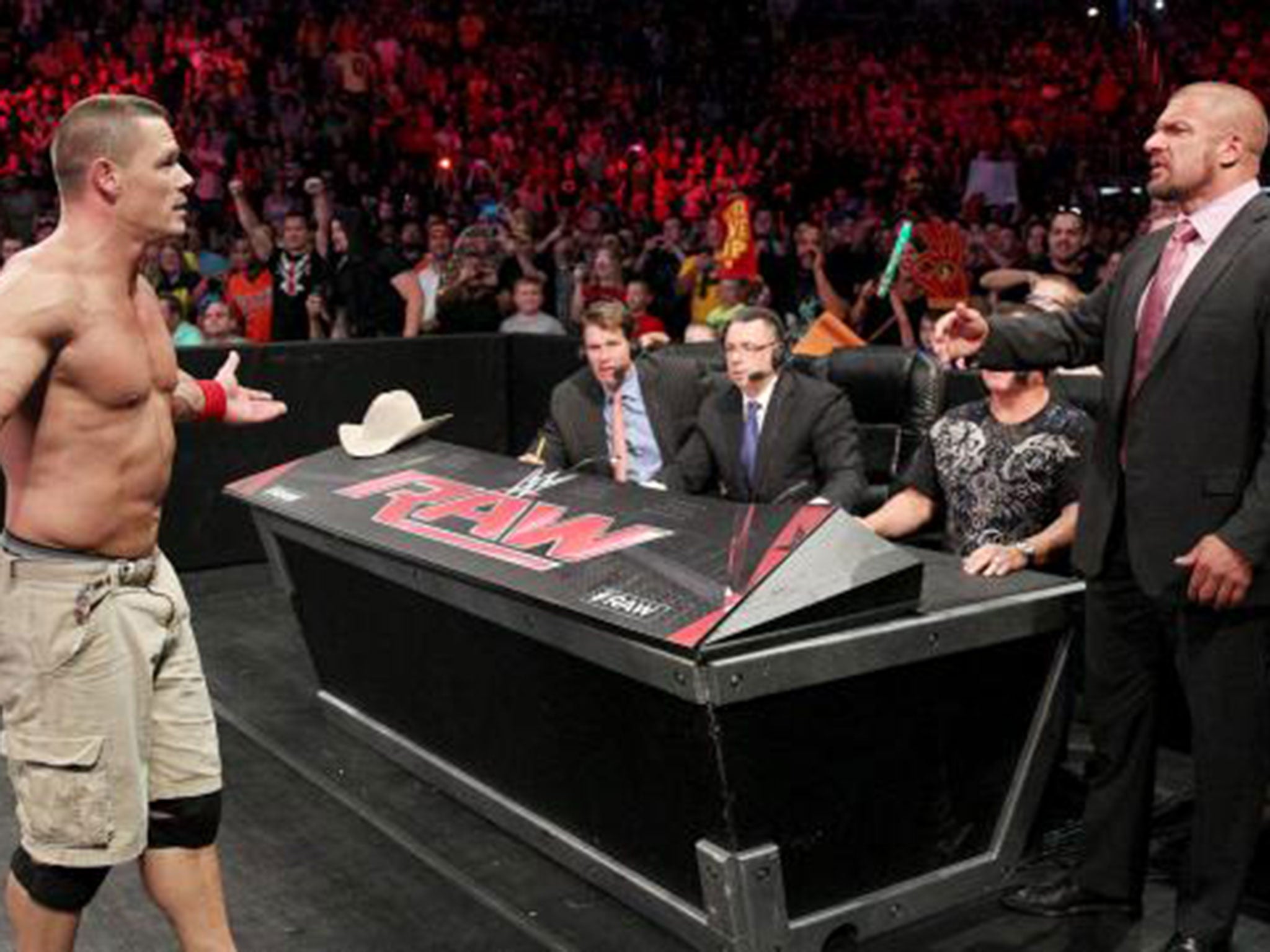 John Cena gestures towards Triple H