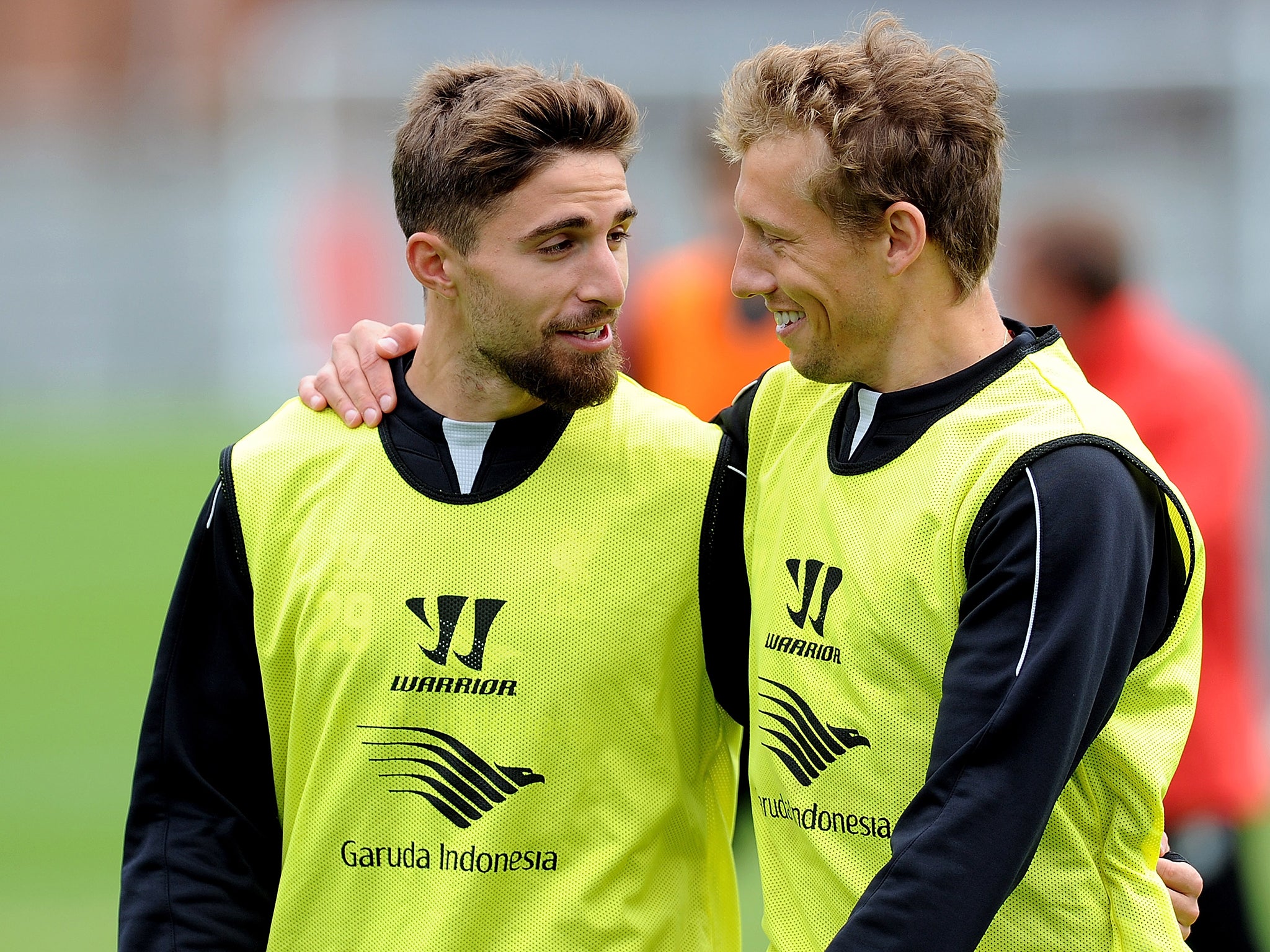 Fabio Borini (L) and Lucas Leiva of Liverpool laughing during a training session