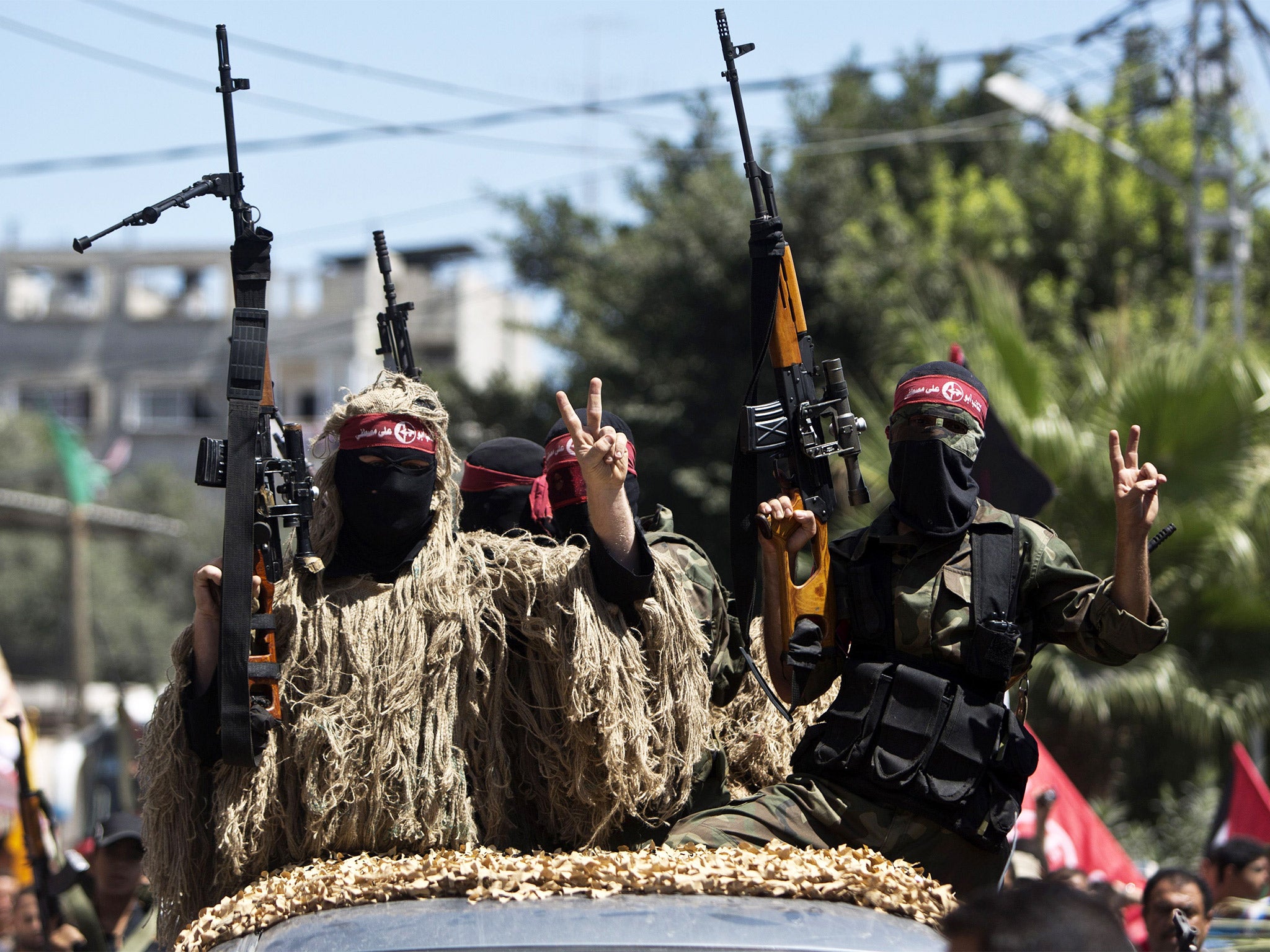 Masked Palestinian PFLP militants celebrating the ceasefire between Israel and Hamas