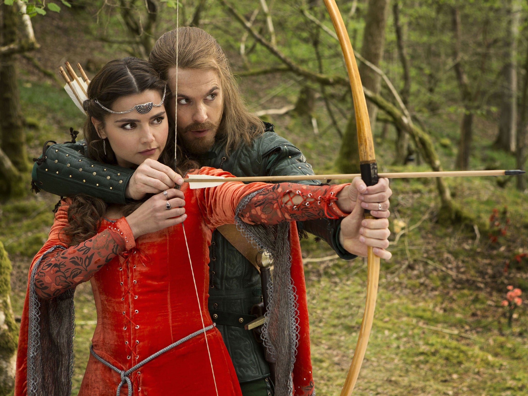 Robin teaches Clara to shoot an arrow