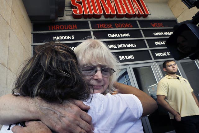 Long time employees hug as they leave the closing Showboat Casino Hotel, which shut down after 27 years on the Boardwalk
