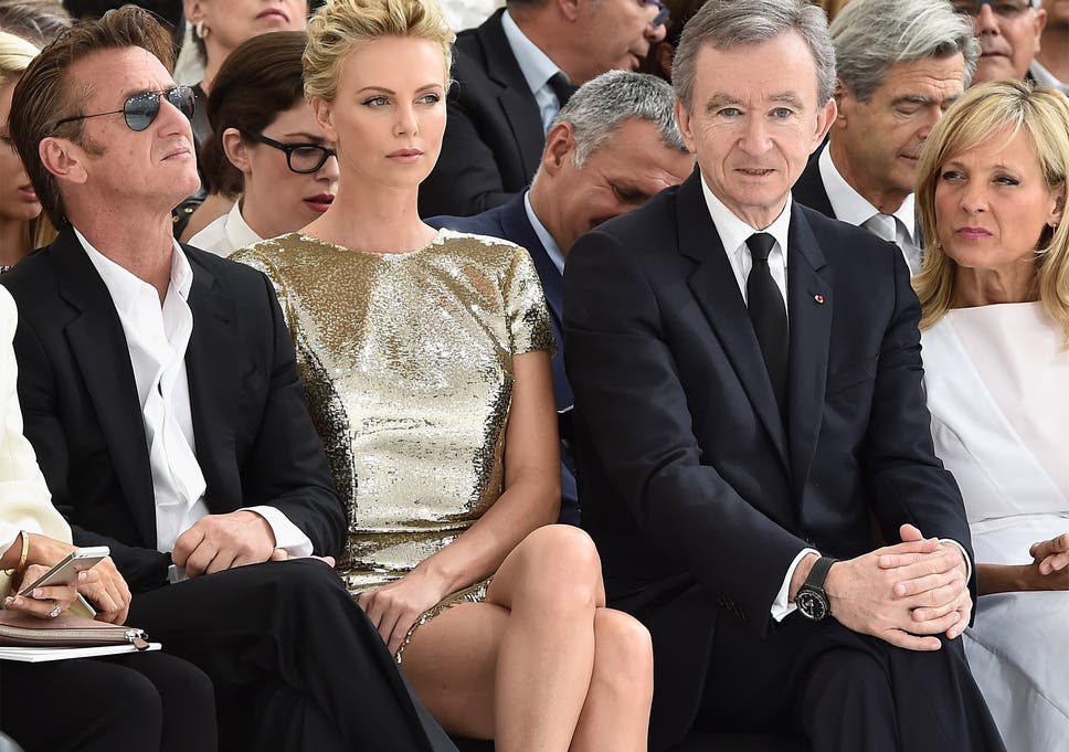 Actors Sean Penn (left) and Charlize Theron joined Bernard Arnault and wife Helene at this yearâs Paris Fashion Week 