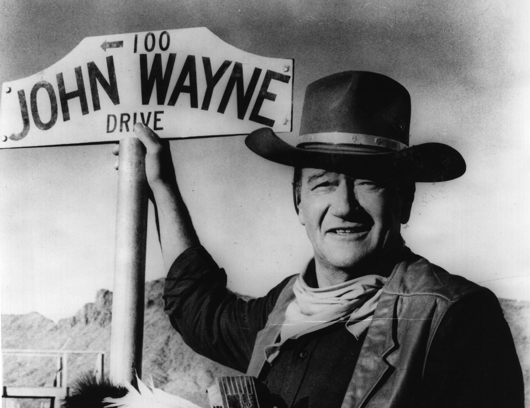 The late actor John Wayne, who starred in several Andrew V McLaglen films, with his sign in 1966