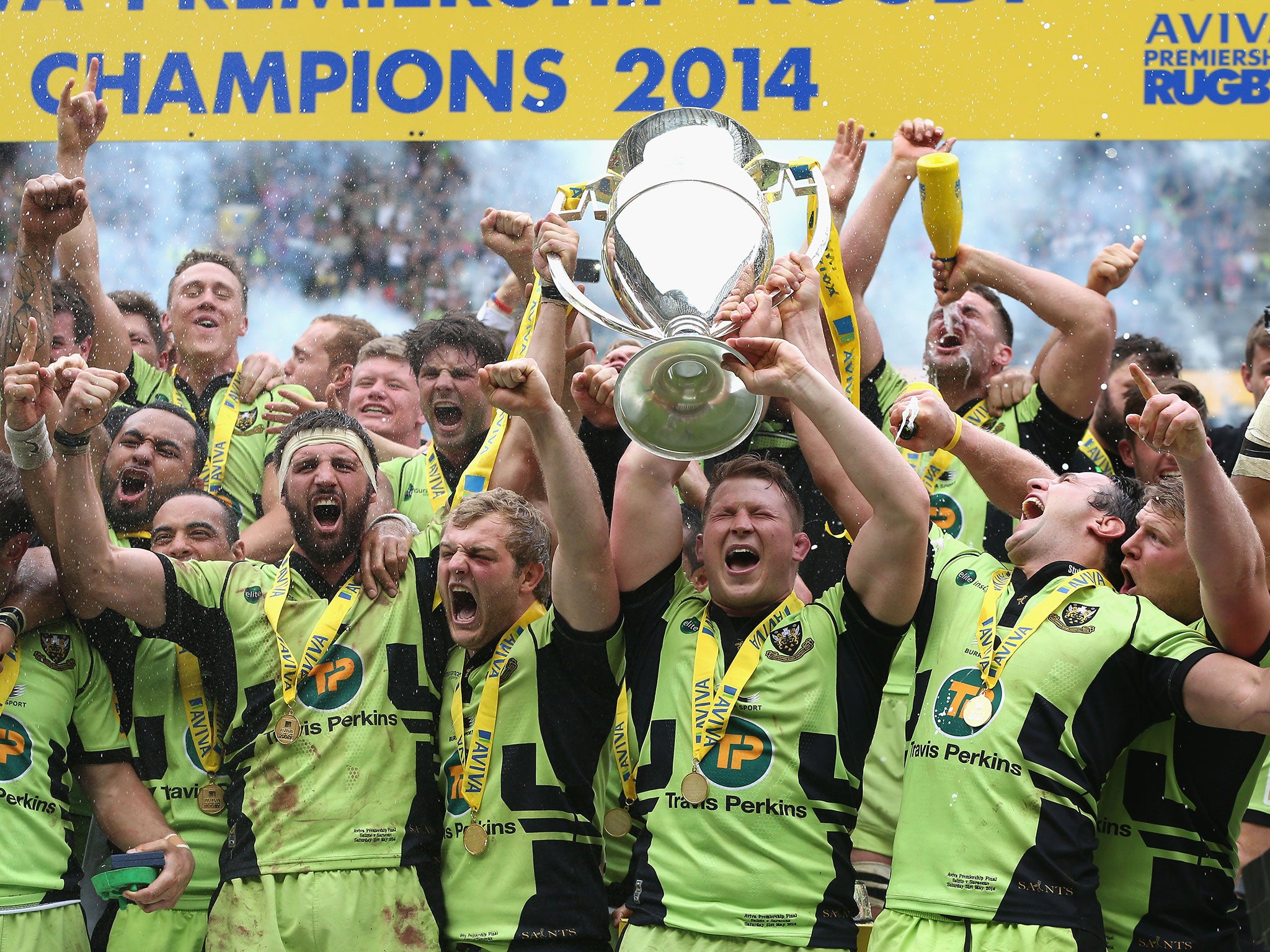 Northampton Saints team captain Dylan Hartley (right) and match captain Tom Wood raise the trophy after their victory during the Aviva Premiership Final between Saracens and Northampton in May