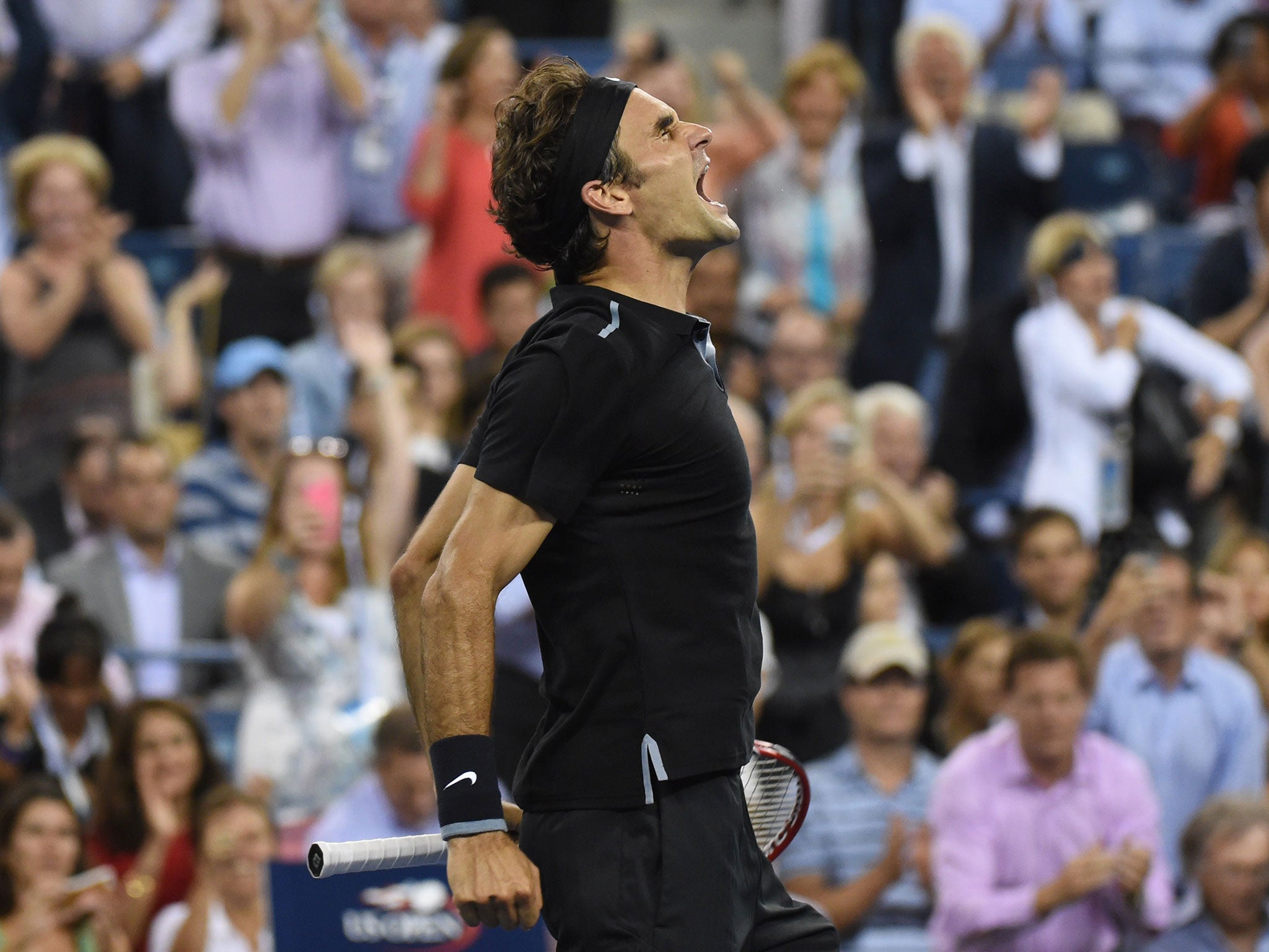 Roger Federer celebrates victory over Gael Monfils at the US Open