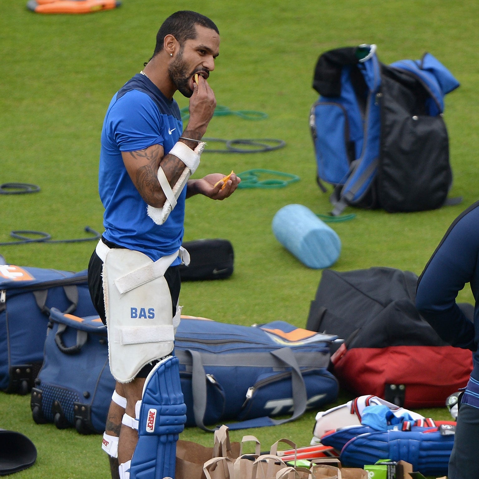 Shikhar Dhawan with a mouthful of chips