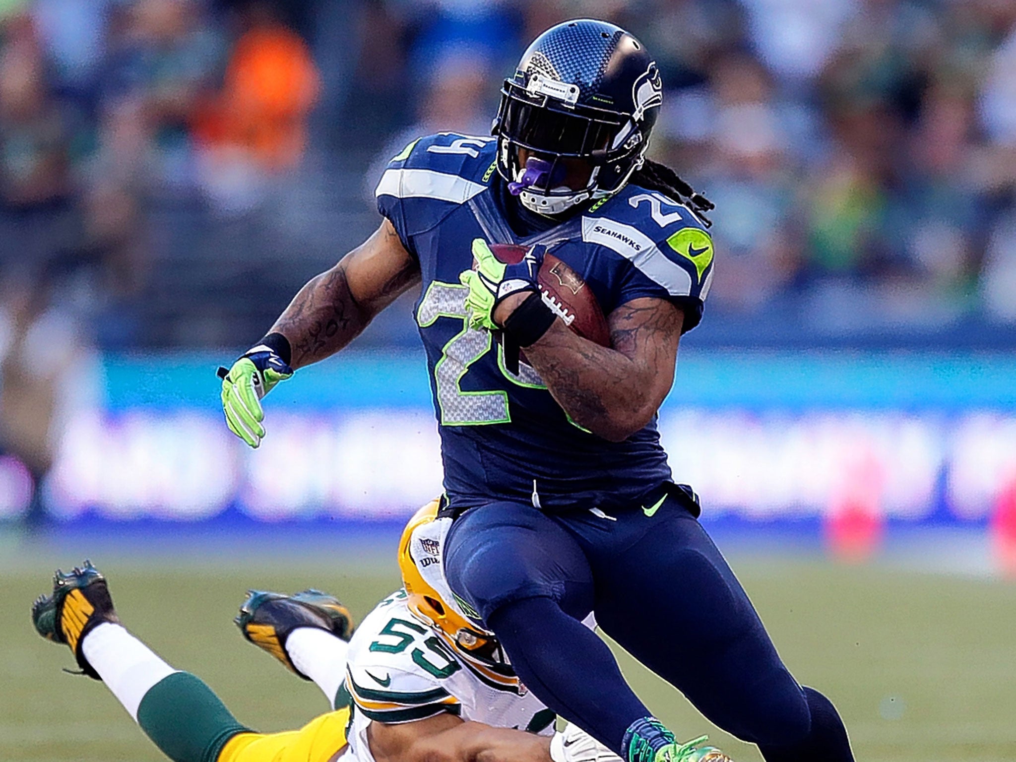 Seattle Seahawks’ running back Marshawn Lynch avoids the tackle of Brad Jones in the reigning champions’ 36-16 defeat of the Green Bay Packers on Thursday