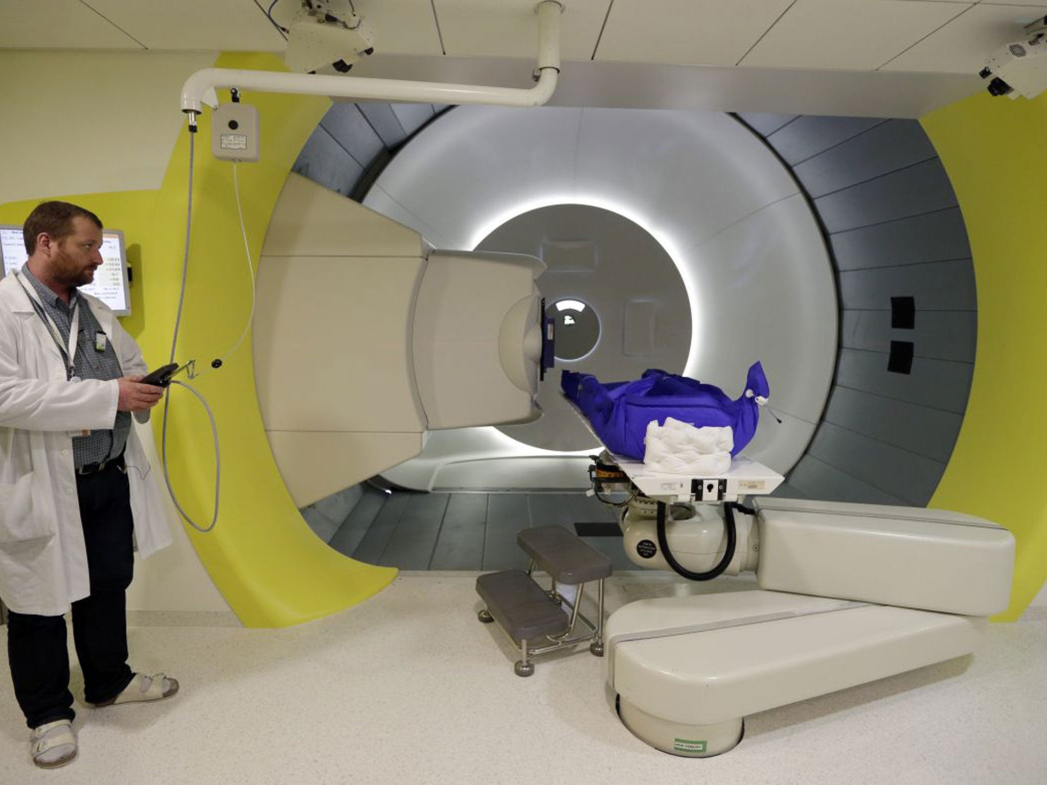Dr. Vladimir Vondracek operates a machine in a proton therapy treatment room at Proton Therapy Center in Prague, Czech Republic