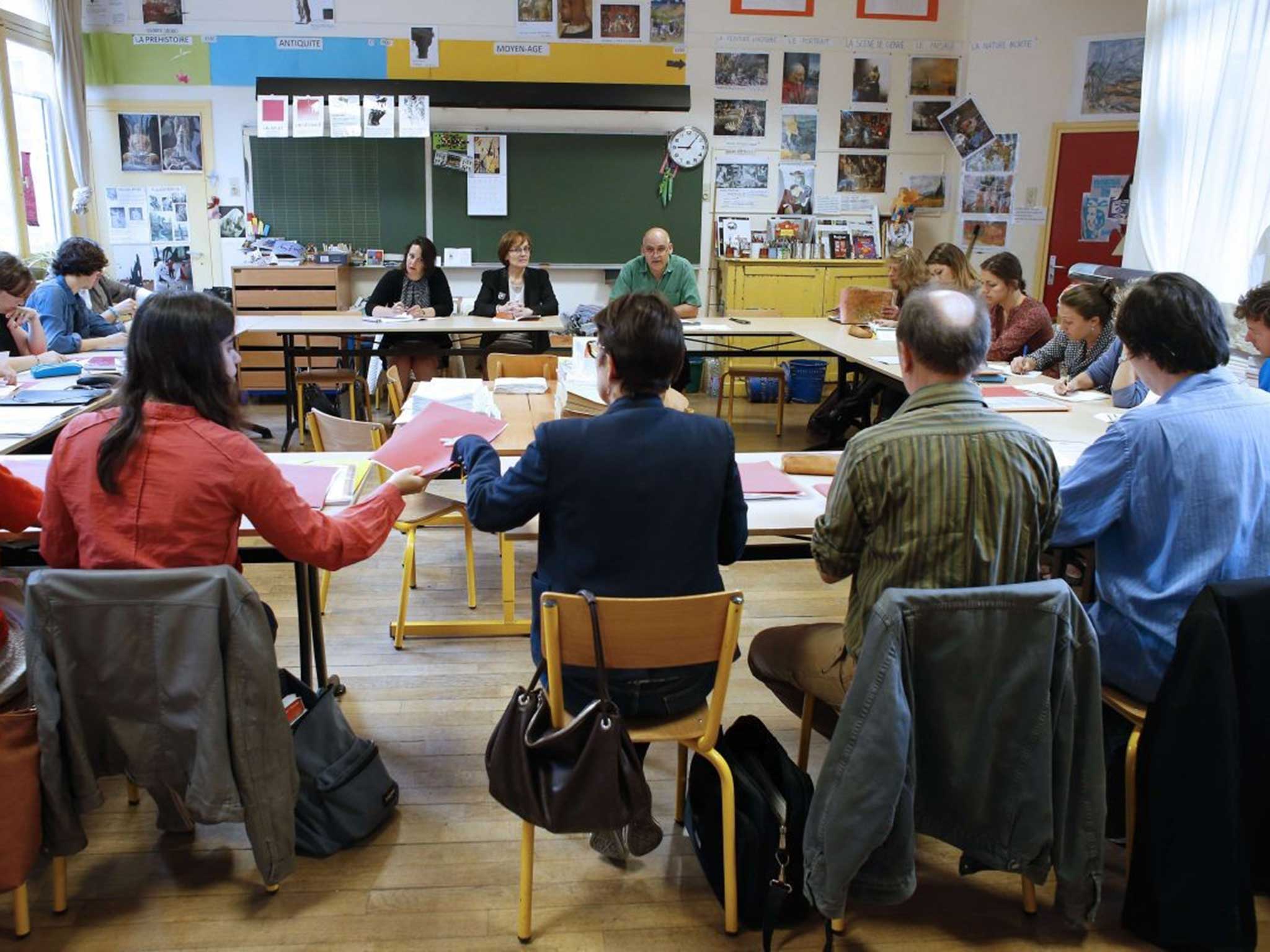 Teachers sit in on a staff meeting