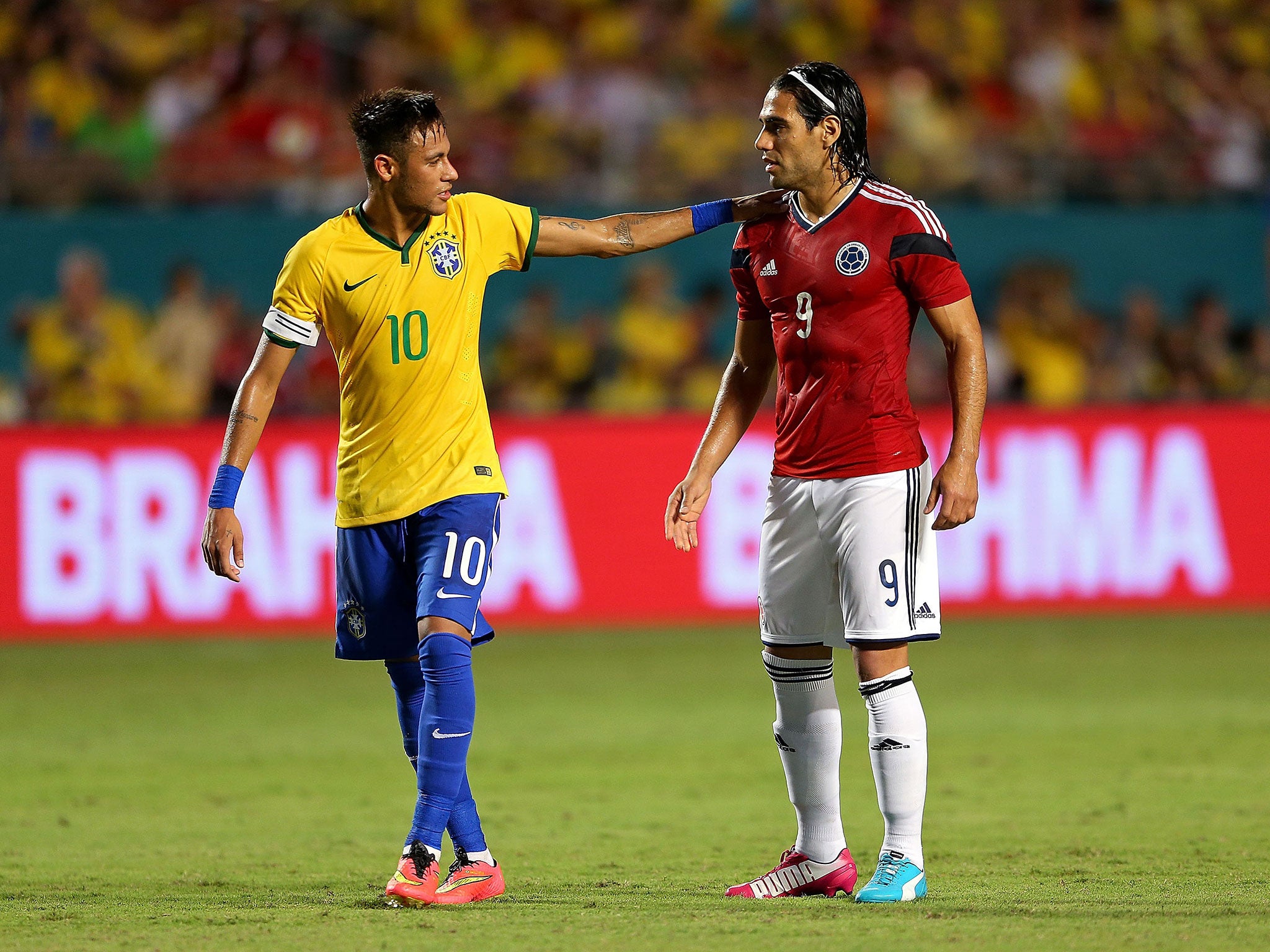 Brazil's Neymar speaks to Colombia striker Radamel Falcao