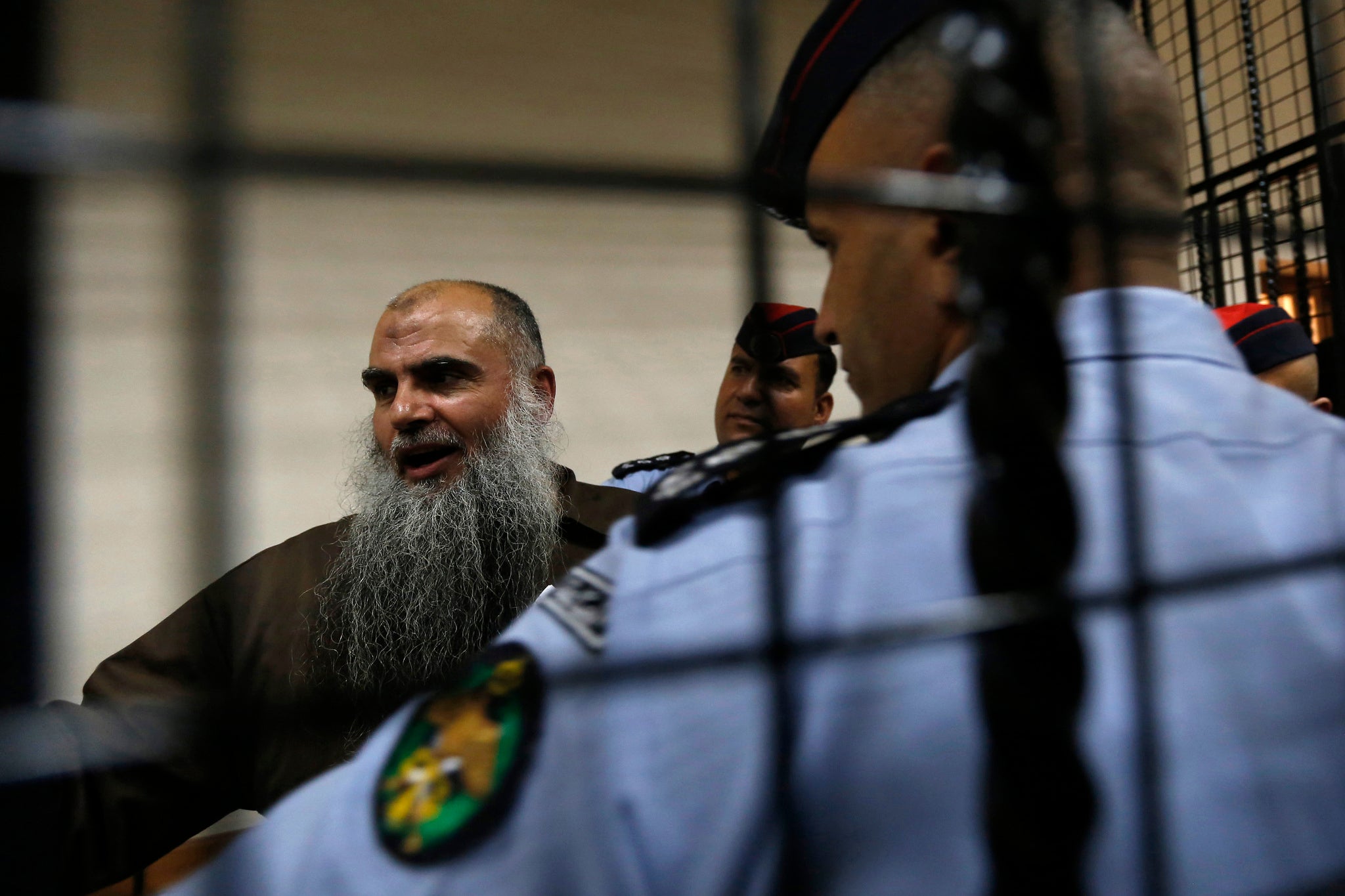 Radical Muslim cleric Abu Qatada speaks to the media after his hearing at the State Security Court in Amman on 7 September 2014
