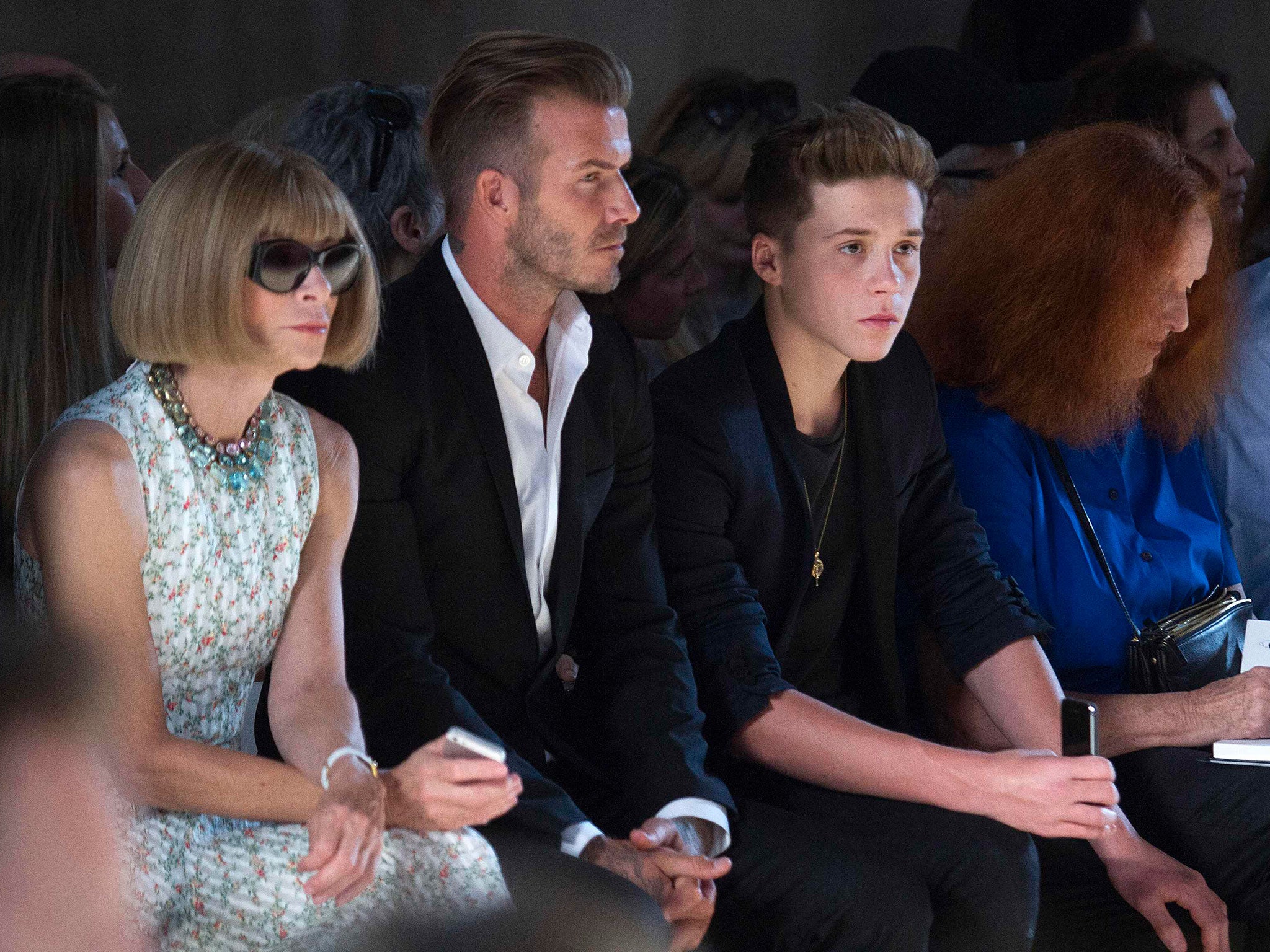 David Beckham, centre, on the front row with Vogue editor Anna Wintour, left, and Brooklyn Beckham, right