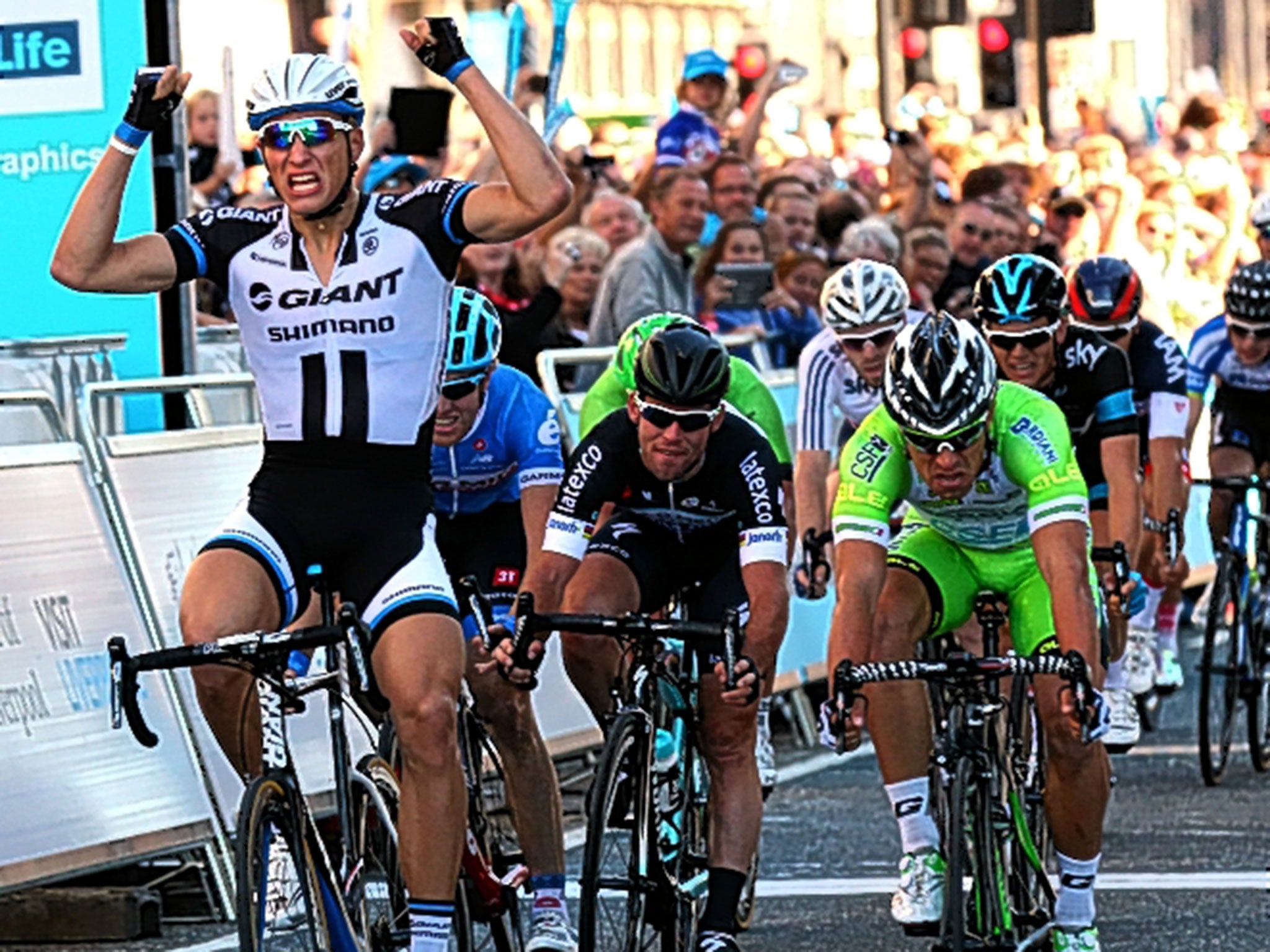 Marcel Kittel celebrates as he wins stage one of the Tour of Britain in Liverpool ahead of Nicola Ruffoni (right) and Mark Cavendish in third (centre)