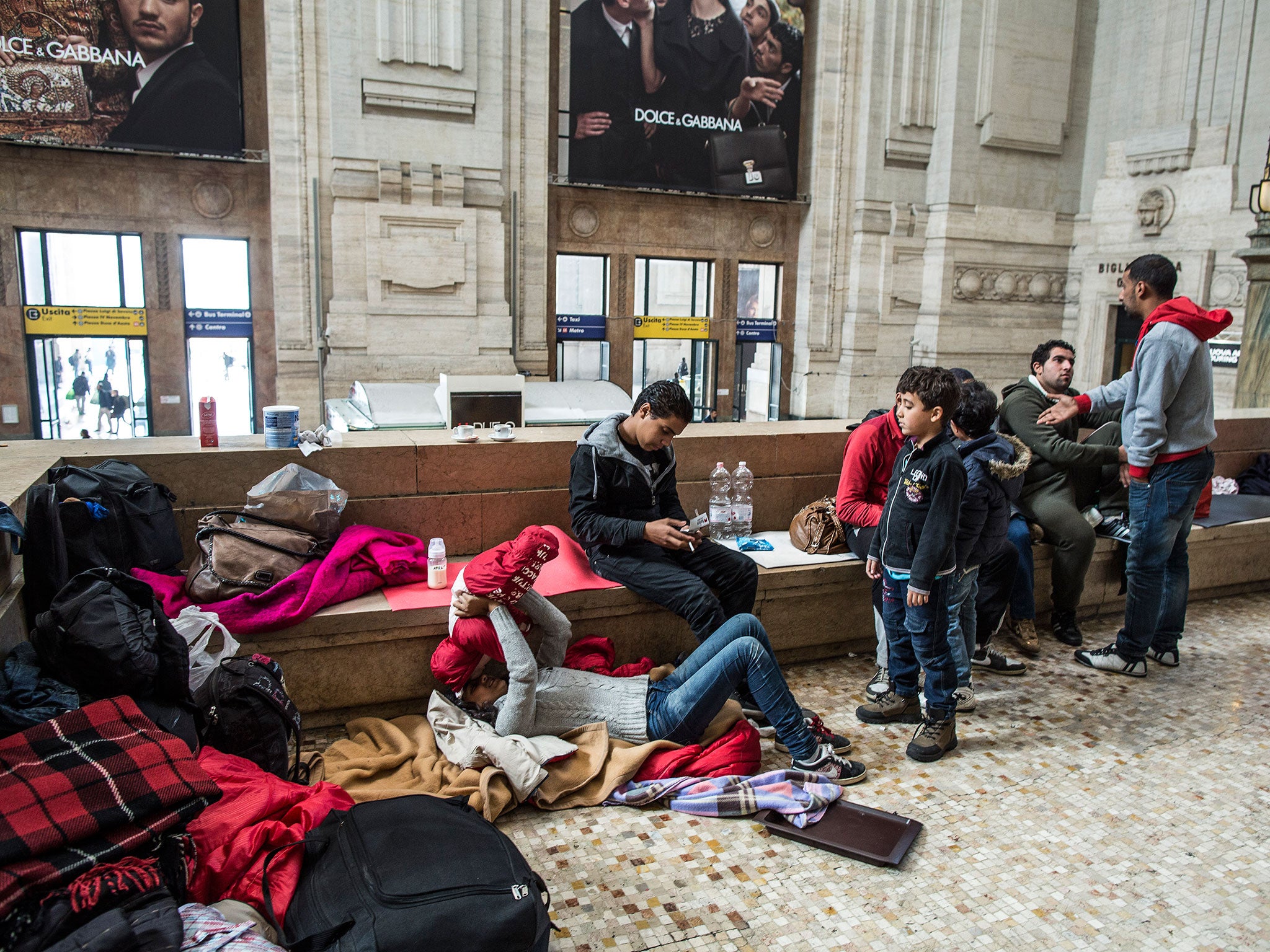 Syrian refugees wait at Milan’s Central train station, hoping to reach northern Europe. The authorities provide advice, a play area and a shuttle service to a nearby camp
