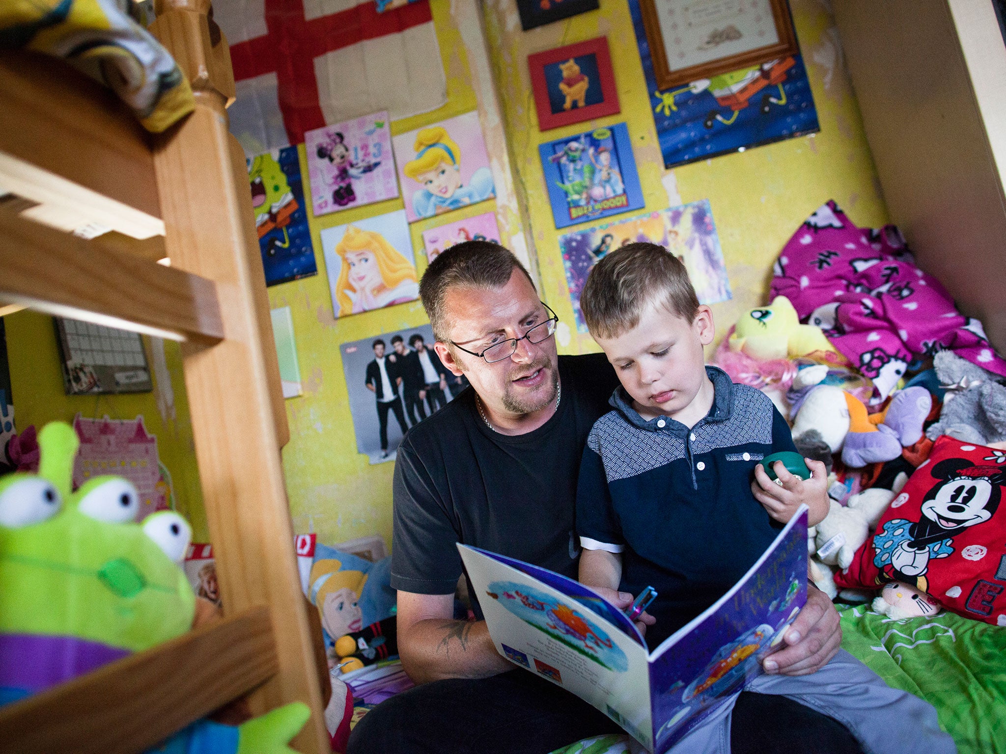 Damien (39) reads to Lucas (5) at home in Sheffield. The family is involved in the FAST  (Families and Schools Together) programme which encourages parents to read to their children at home