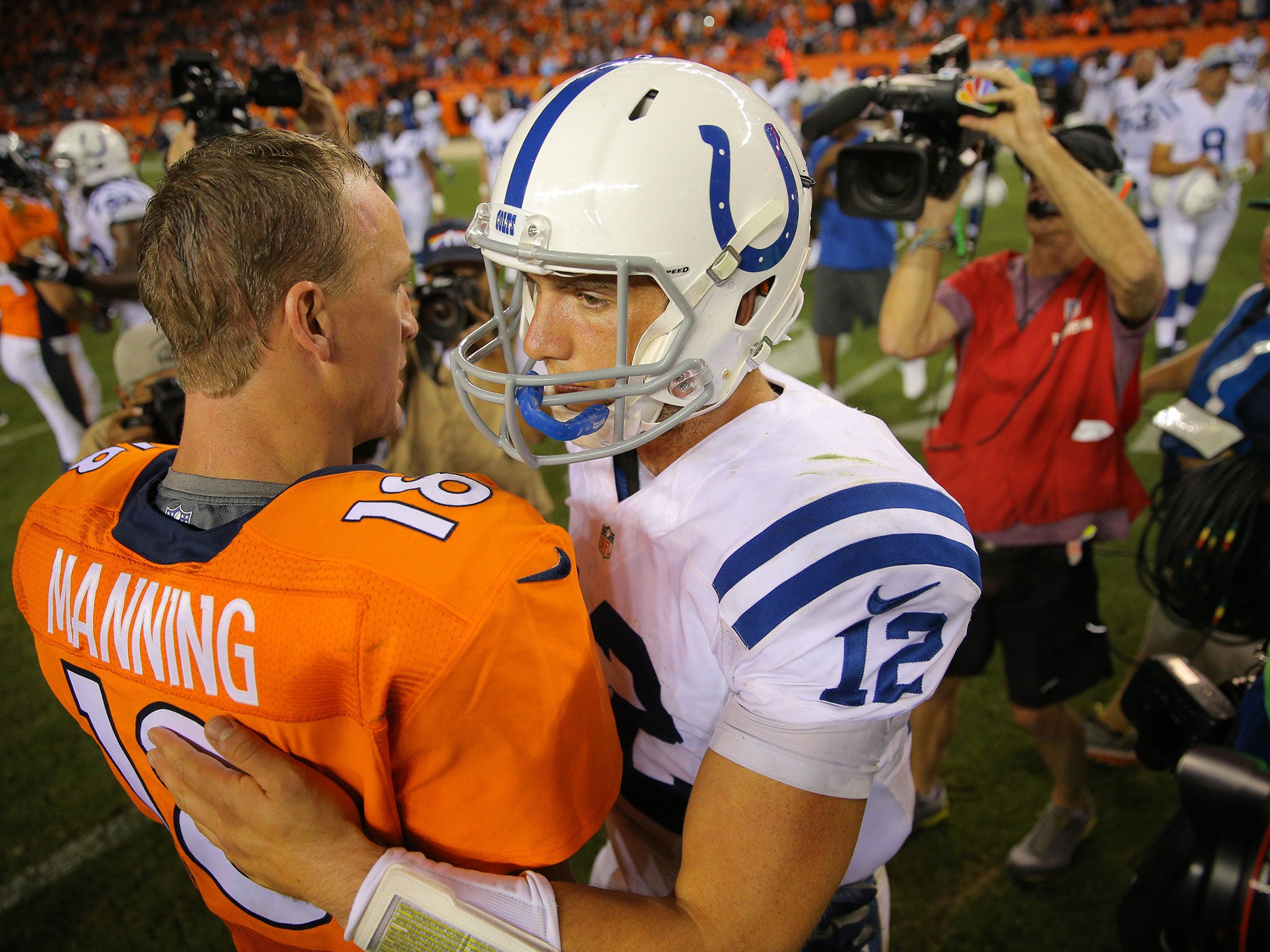 Manning shakes hands with Luck following the Broncos' 31-24 win over the Colts