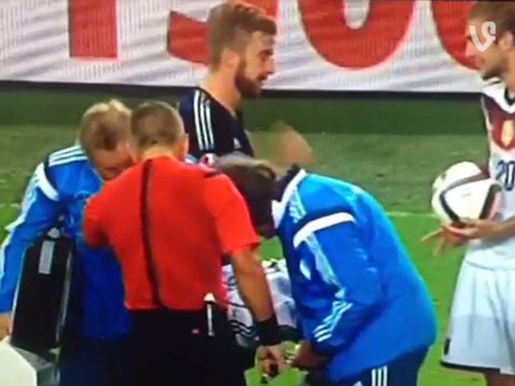 James Morrison (L) and Christoph Kramer (R) appear to play 'Rock, Paper, Scissors' during Germany's 2-1 win over Scotland