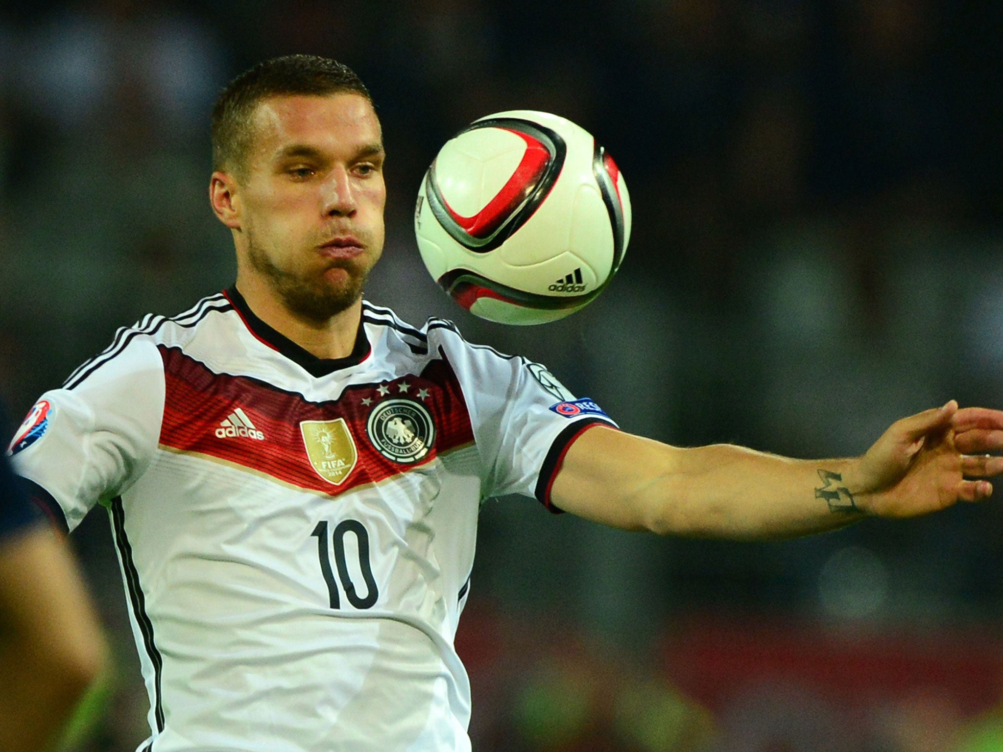 Lukas Podolski controls the ball during Germany's 2-1 win over Scotland last night